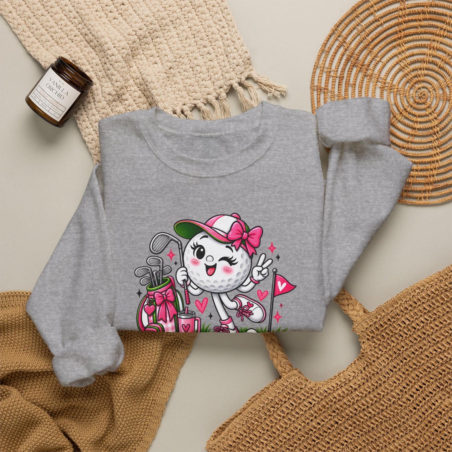 Light gray crewneck sweatshirt with colorful golf-ball character and floral accents