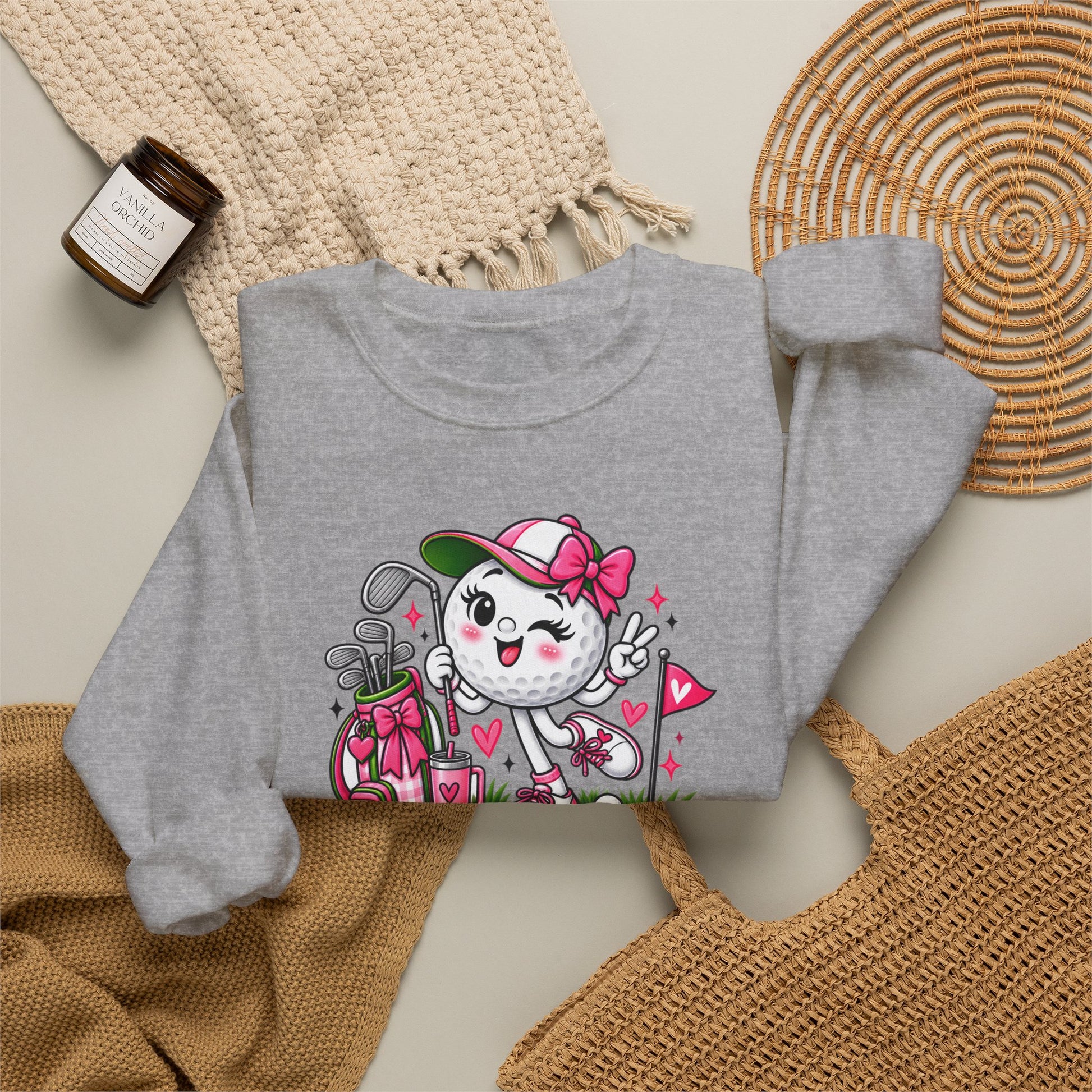 Light gray crewneck sweatshirt with colorful golf-ball character and floral accents