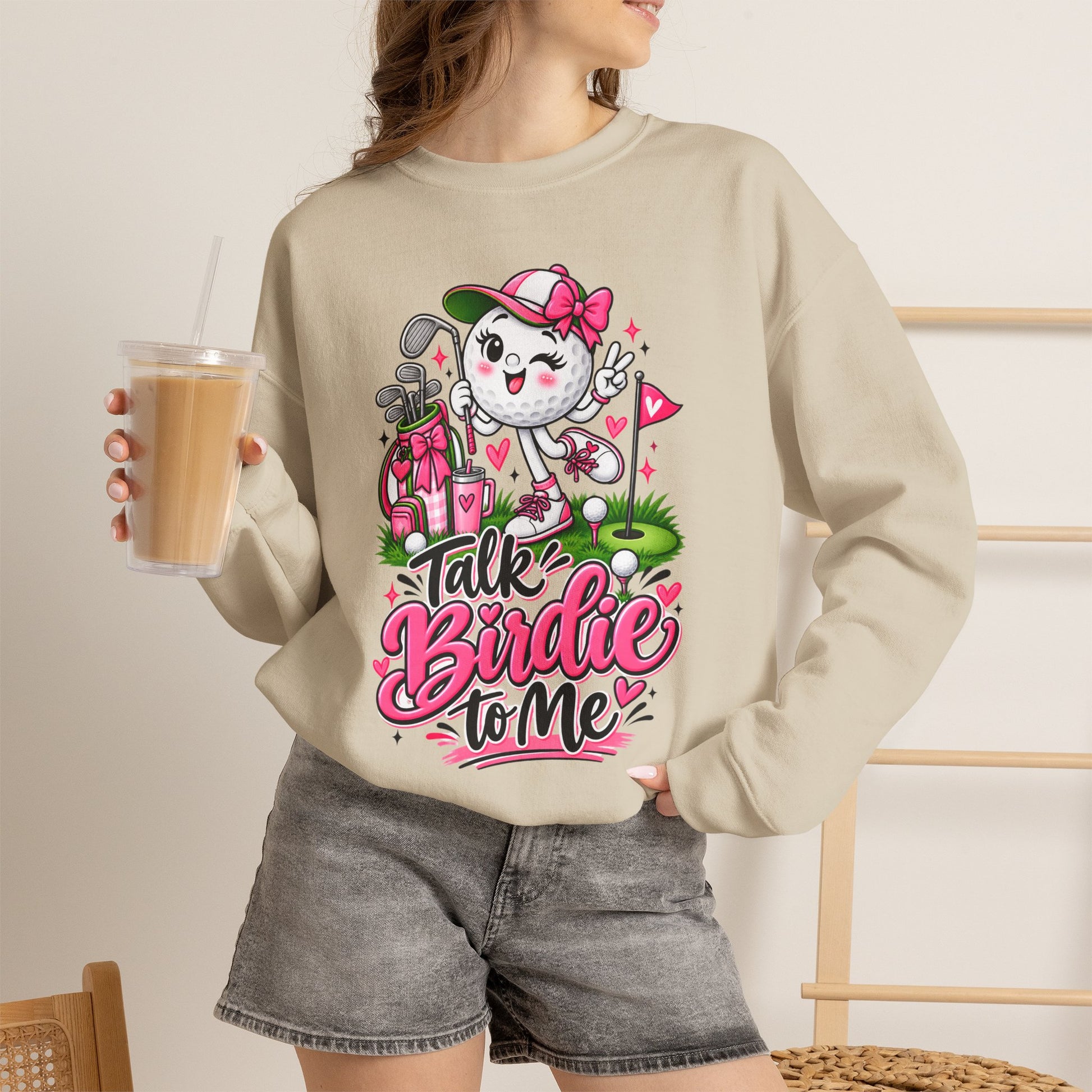Light beige crewneck sweatshirt on model with golf cat character graphic and pink floral hearts