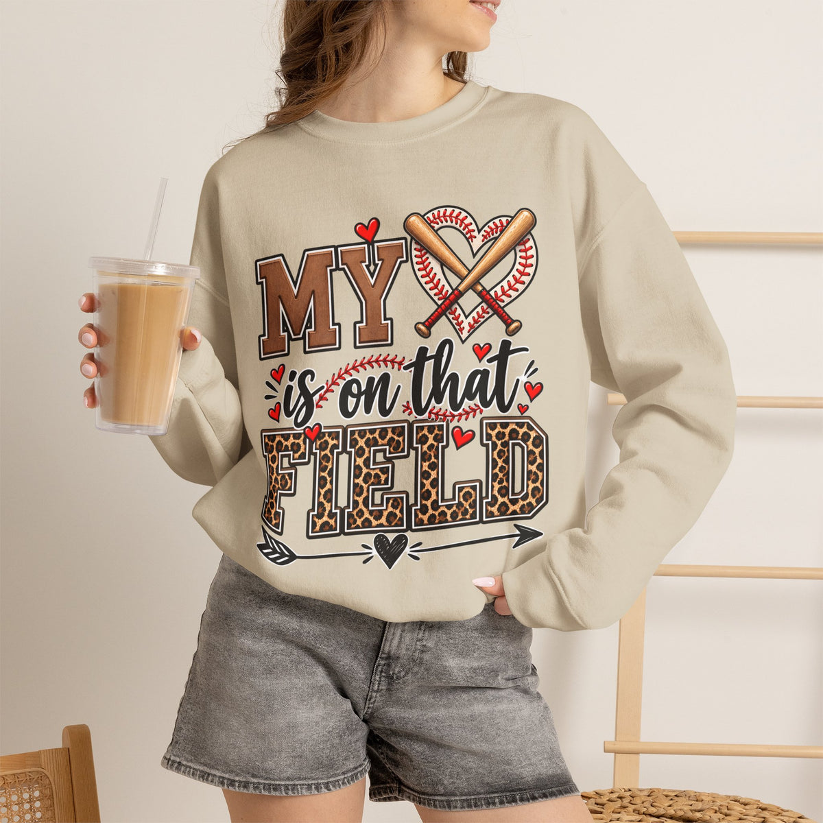 Sand crewneck sweatshirt with baseball heart and crossed bats front graphic, worn