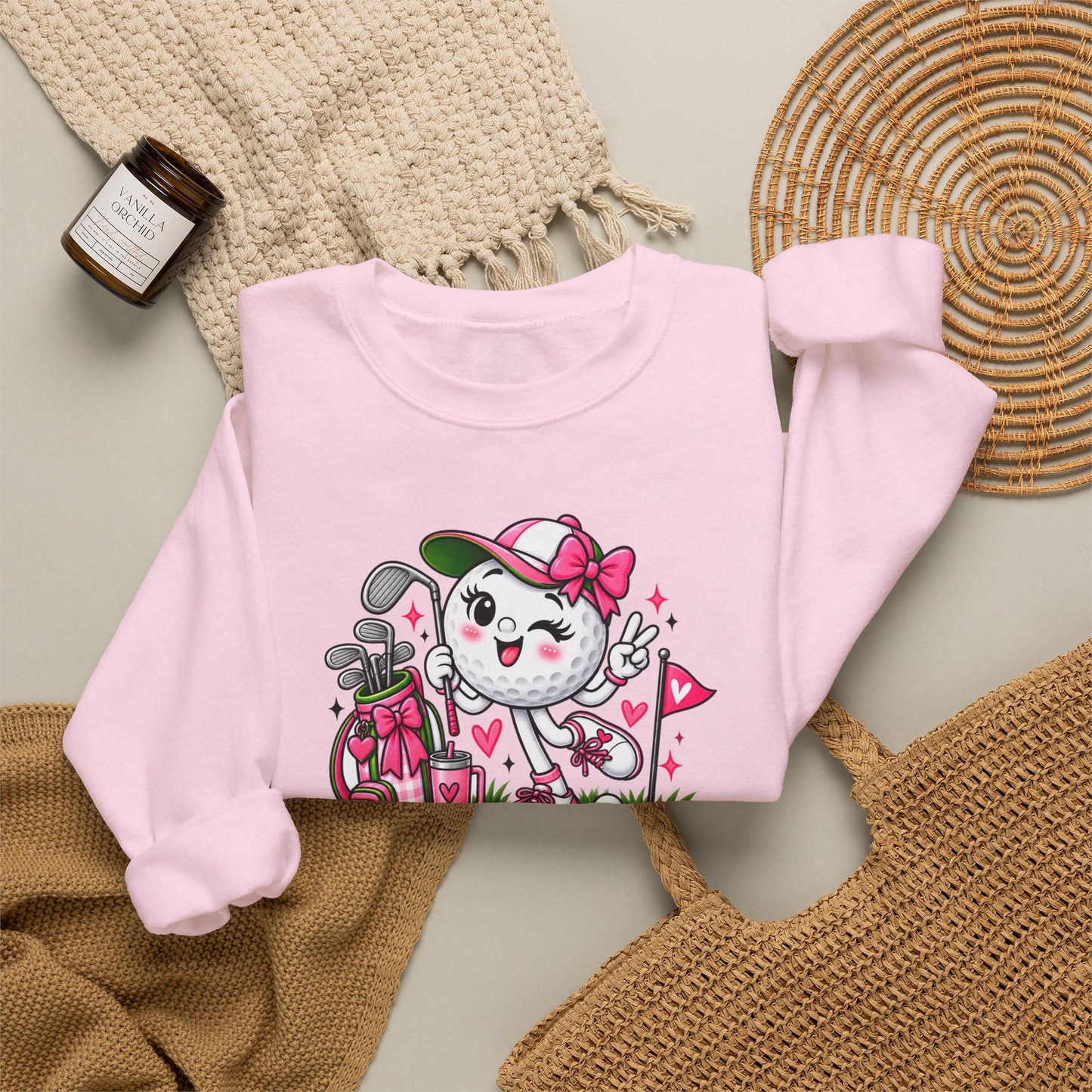 Pink crewneck sweatshirt with colorful golf-ball character graphic on front