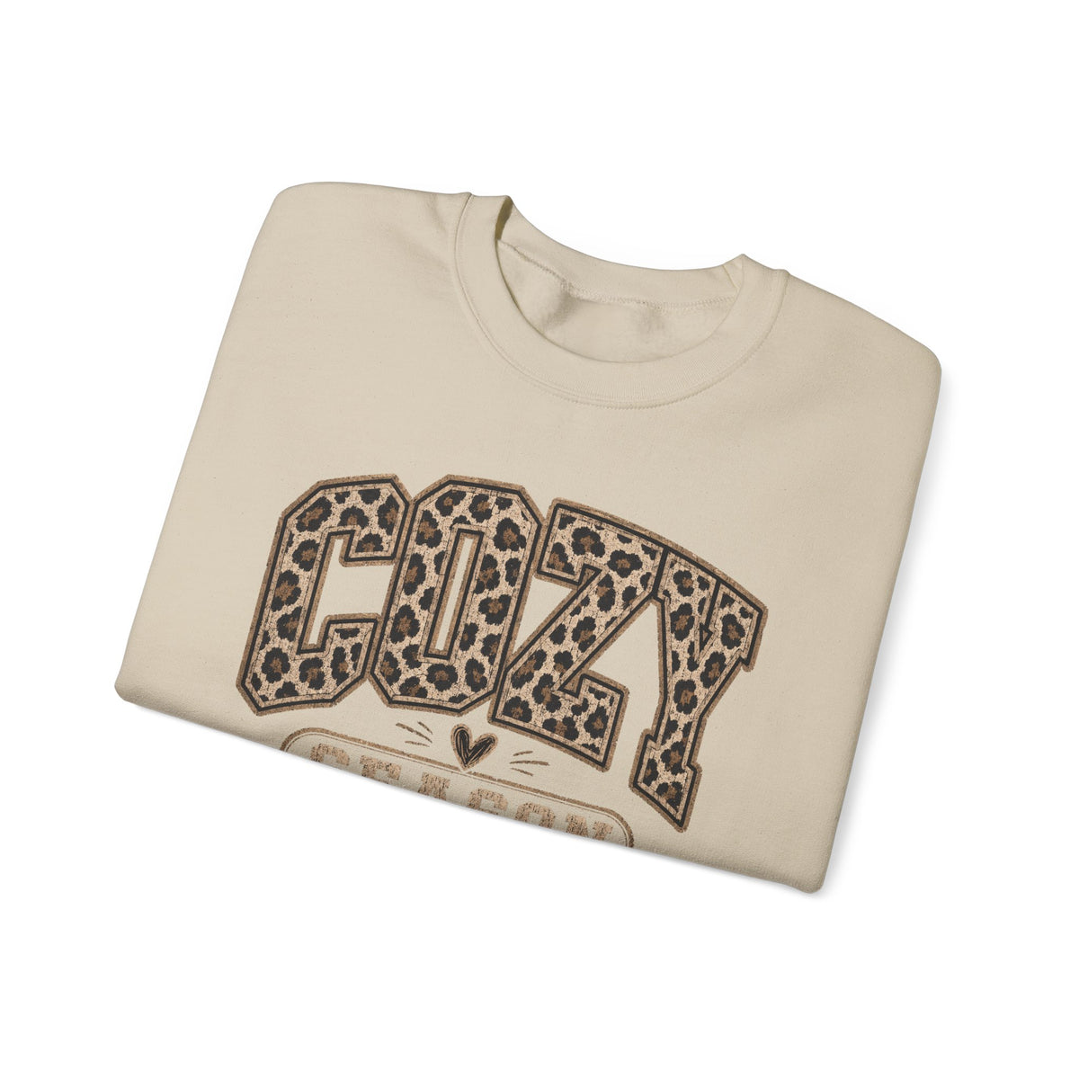 Sand crewneck sweatshirt folded, featuring leopard-print “COZY” front graphic