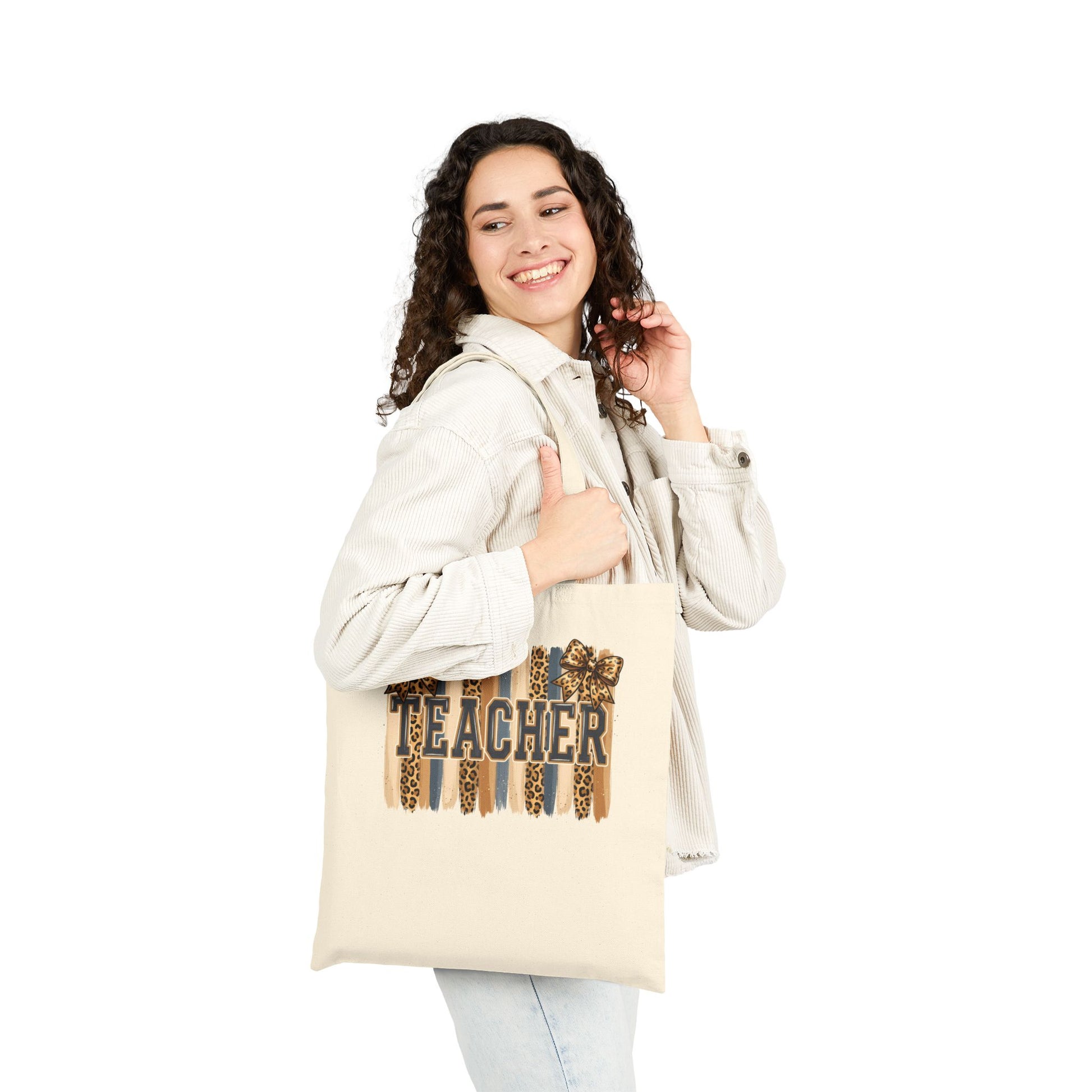 Natural canvas tote bag with leopard “Teacher” graphic, carried by person