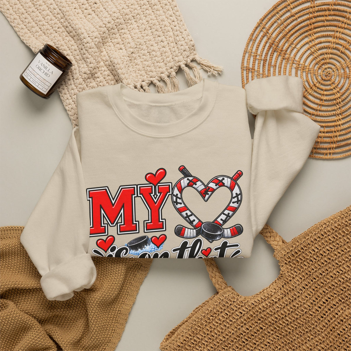 White sweatshirt close-up with front hearts and ice skate graphic