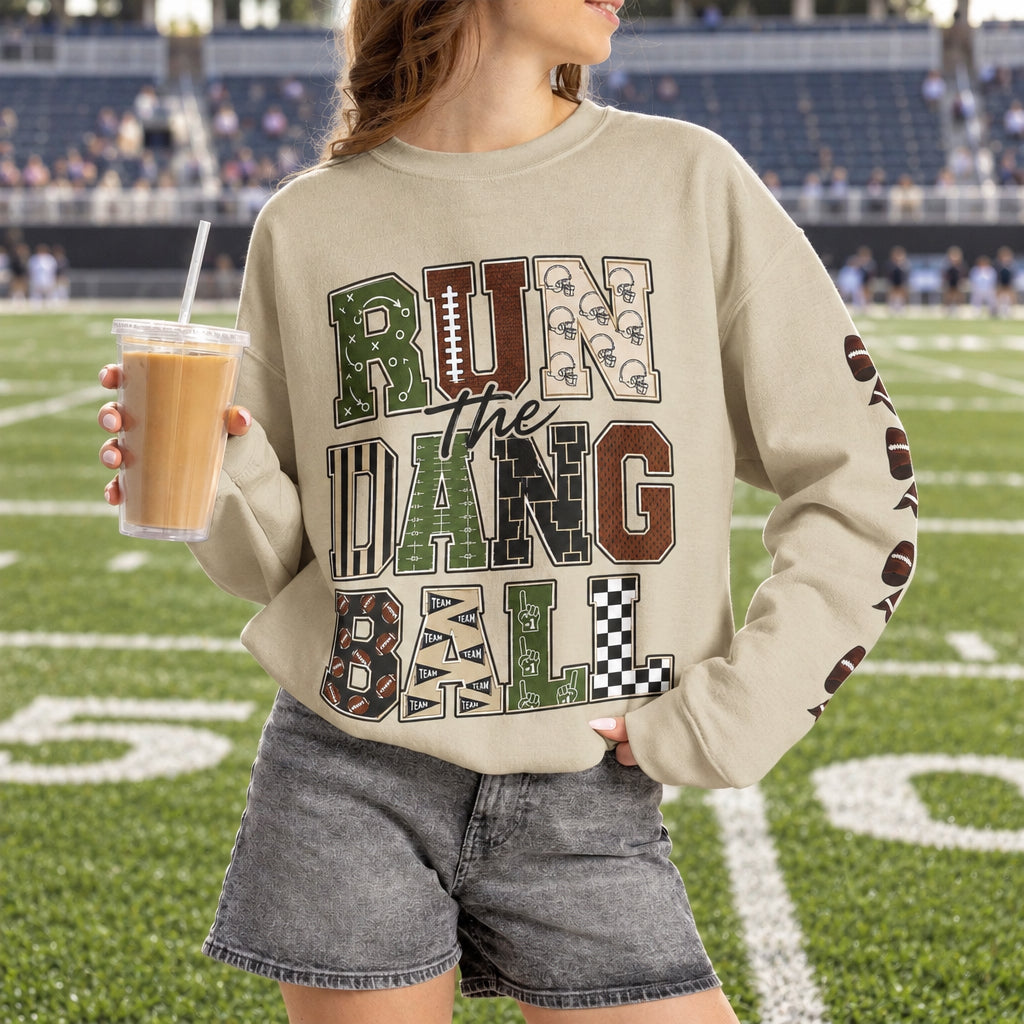 Sand crewneck sweatshirt, front graphic patch lettering and football mask bow accents