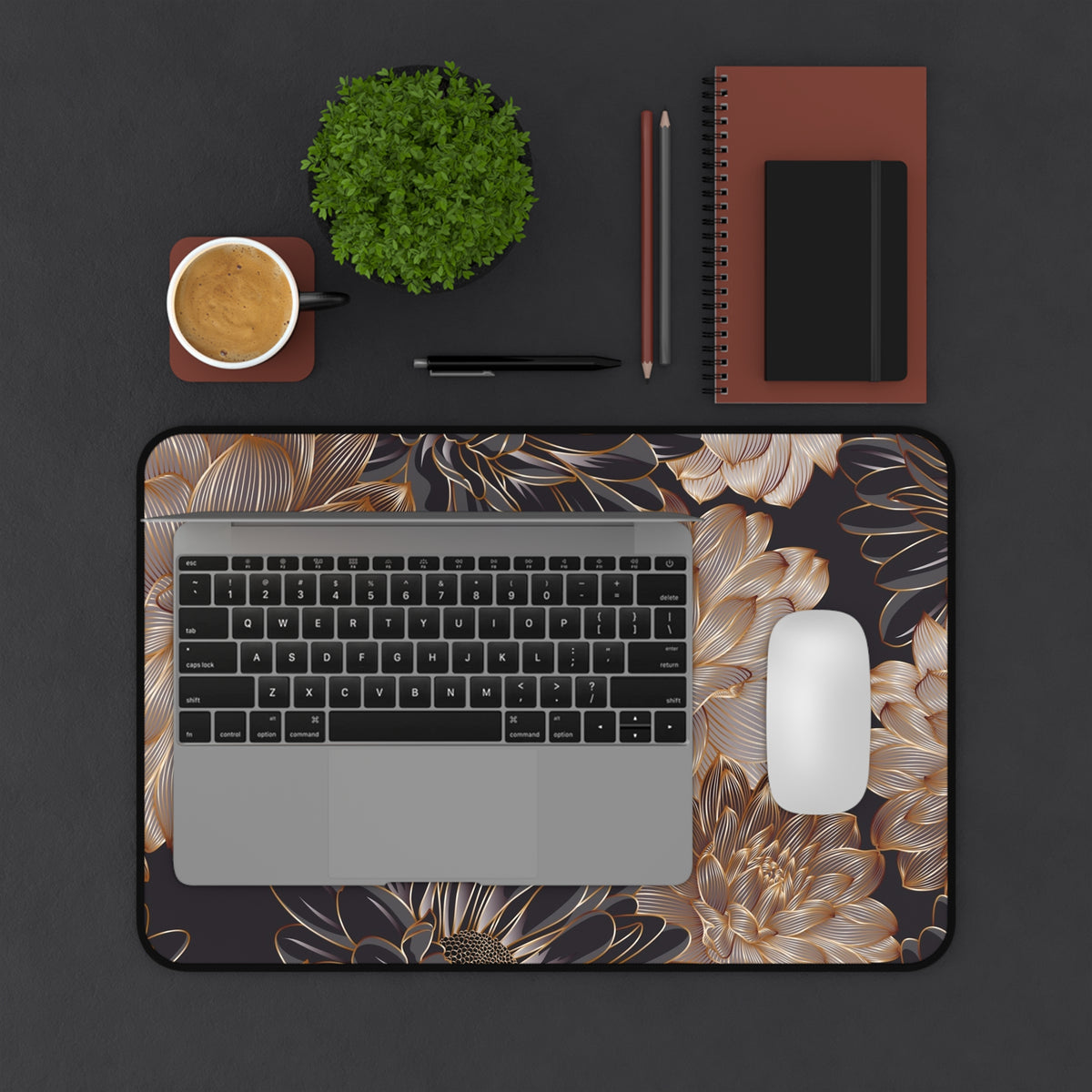 Large desk mat with gold floral design, visible rounded corners and textured fabric