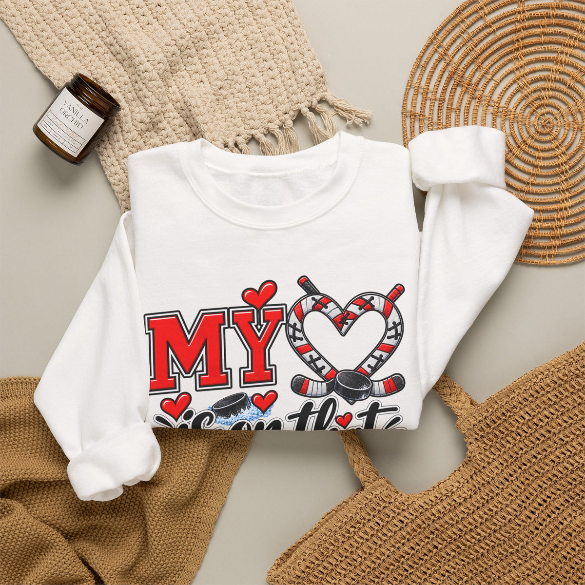White sweatshirt with chest graphic showing hearts and ice skates