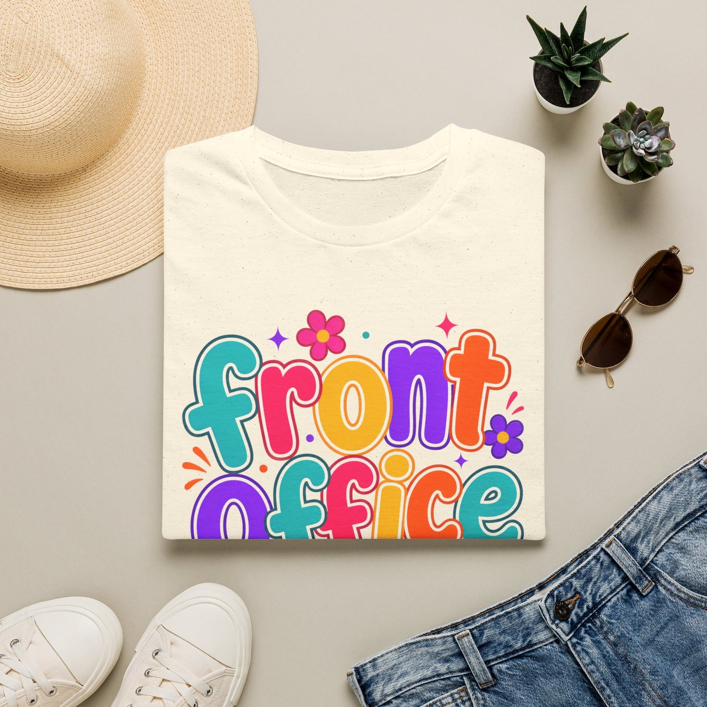 White T-shirt flat lay with colorful “front office” floral text graphic