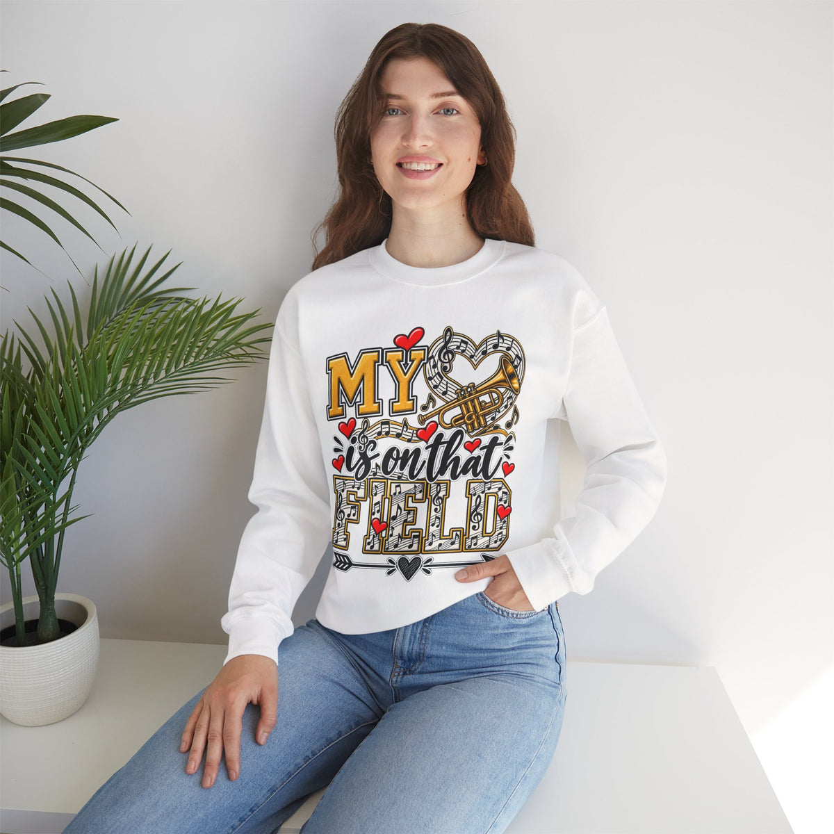 White sweatshirt worn by model; heart and trumpet marching-band graphic