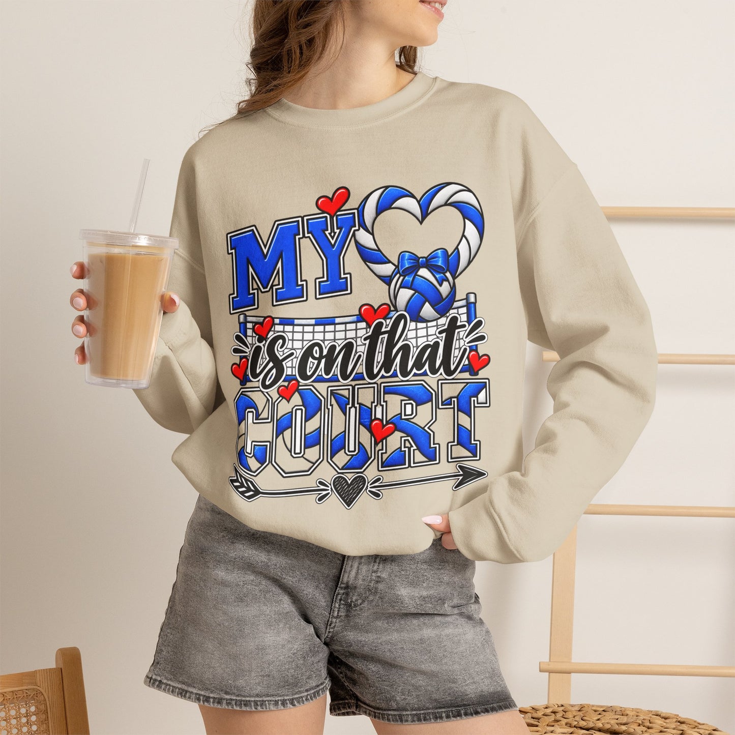 Light sand crewneck sweatshirt with blue volleyball heart graphic on front