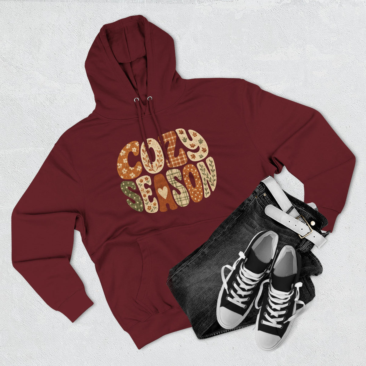 Burgundy fleece hoodie with drawstring hood and front pocket; leopard-style “Cozy Season” graphic