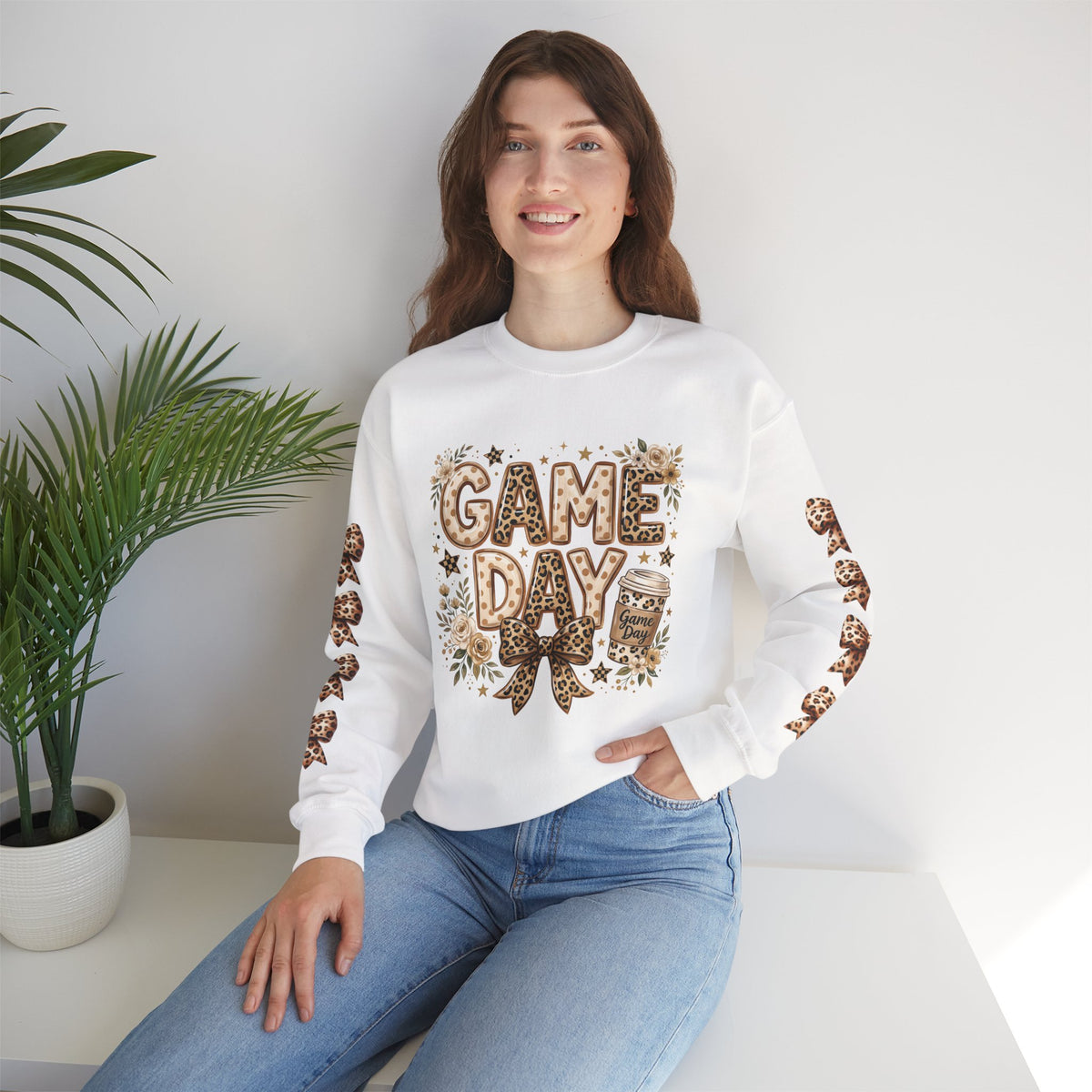 White crewneck sweatshirt with “GAME DAY” front graphic and leopard bow sleeve accents