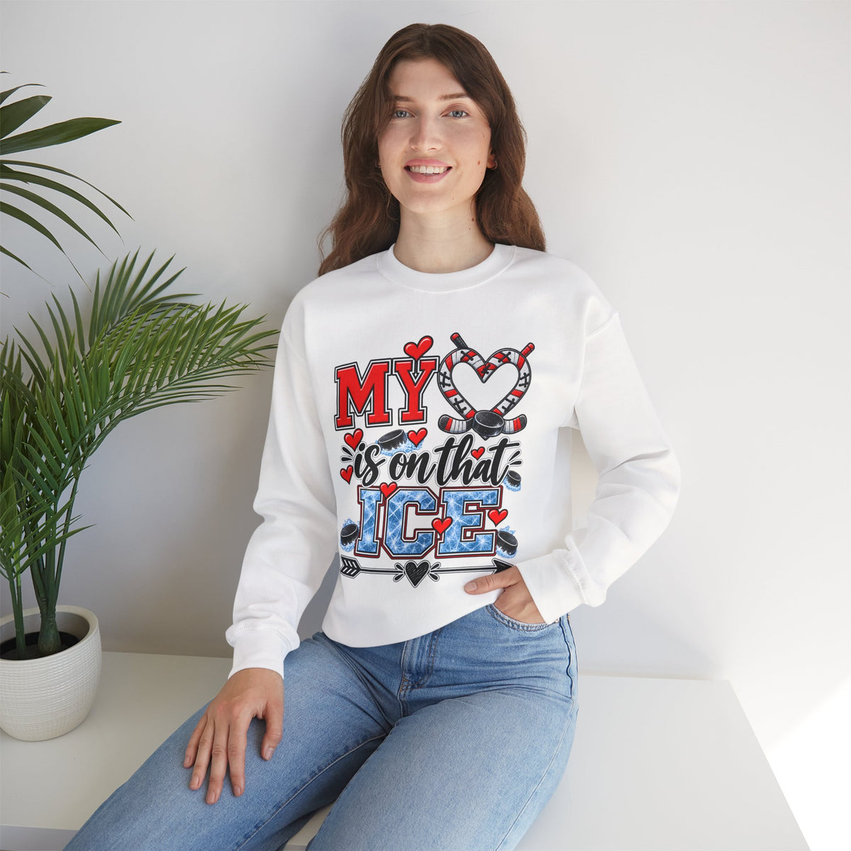 White sweatshirt with front heart and ice skate graphic, worn by a model