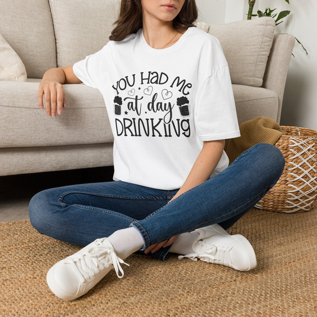 White T-shirt on seated model, “You Had Me at Day Drinking” graphic on chest