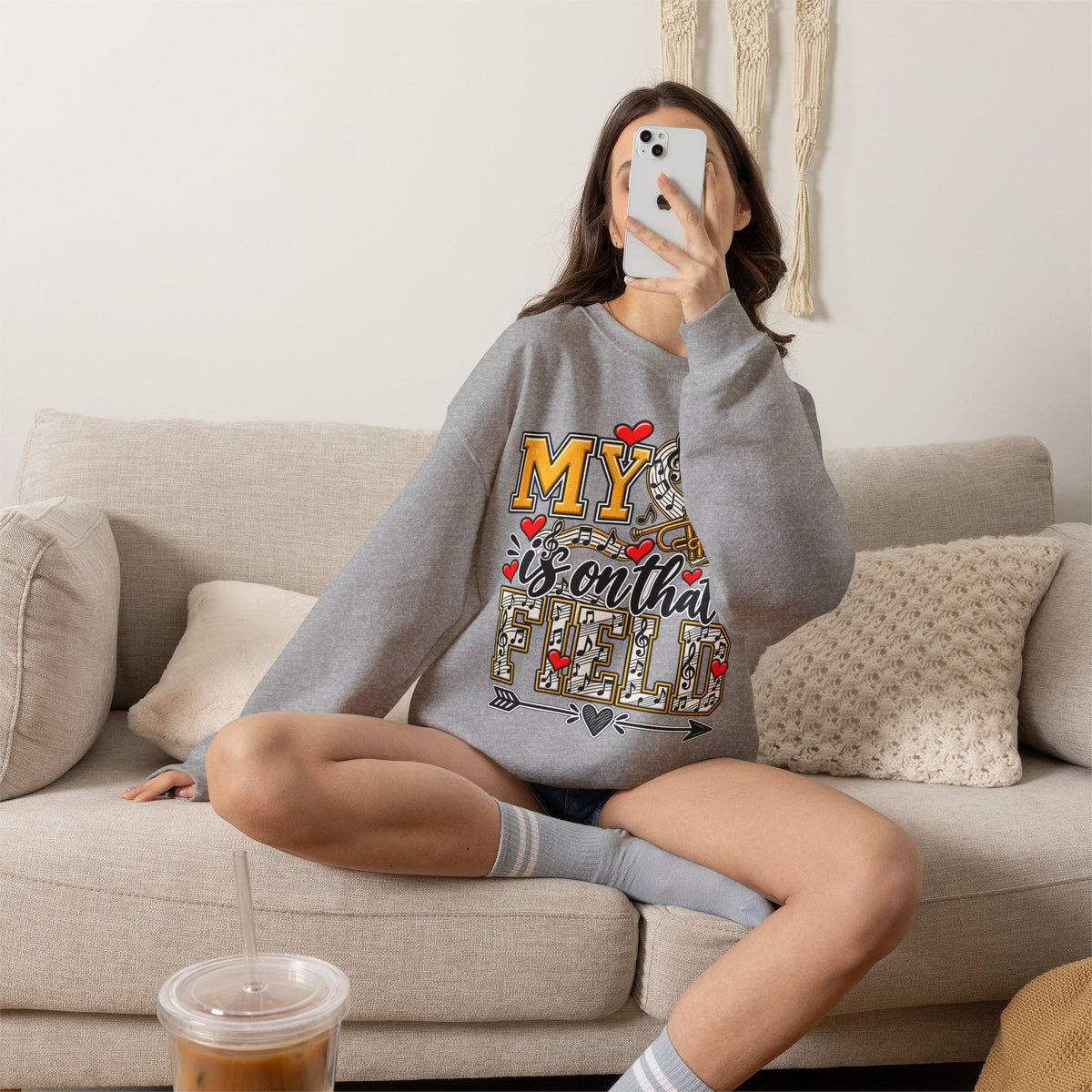 Grey sweatshirt with large “My” trumpet graphic and heart accents on front