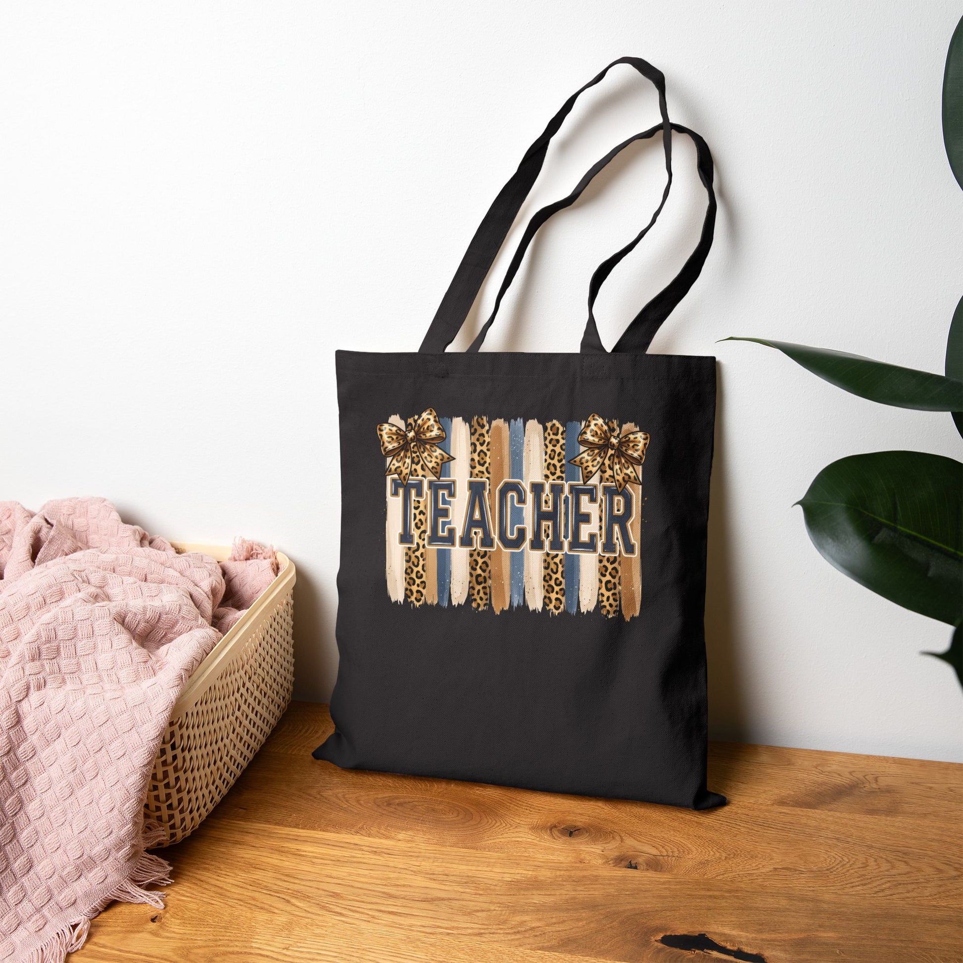 Black canvas tote bag with leopard “Teacher” graphic, front upright