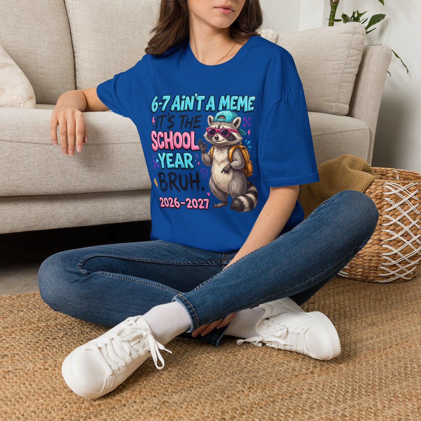 Royal blue crewneck T-shirt with raccoon school year graphic worn by model