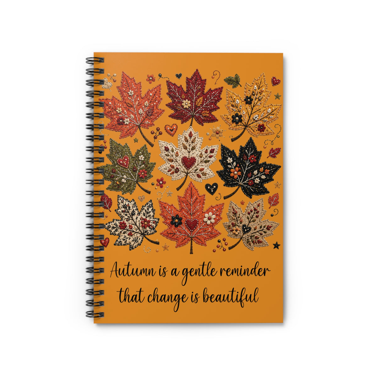 Orange autumn leaf spiral notebook with quote on cover and black spiral binding