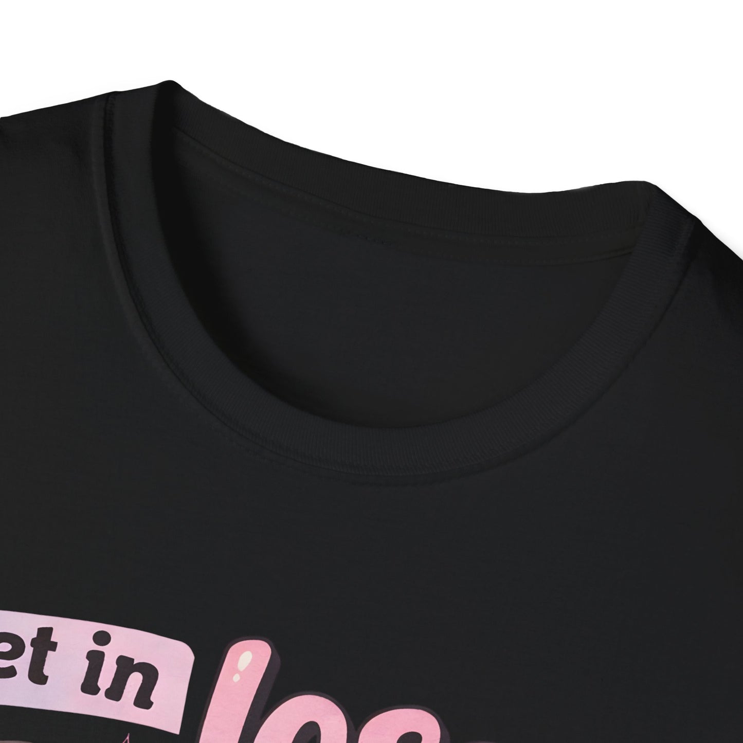 Black T-shirt close-up of chest graphic with pink lettering and cart illustration