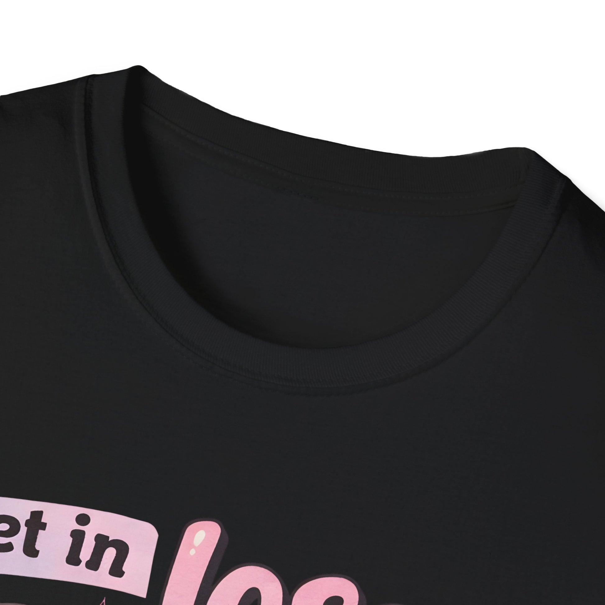 Black T-shirt close-up of chest graphic with pink lettering and cart illustration