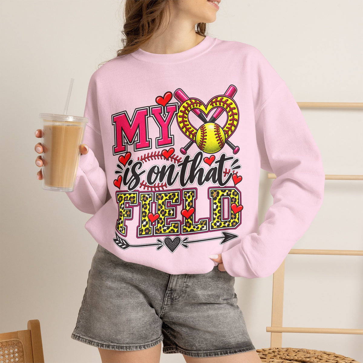 Light pink crewneck sweatshirt with large softball heart graphic; long sleeves