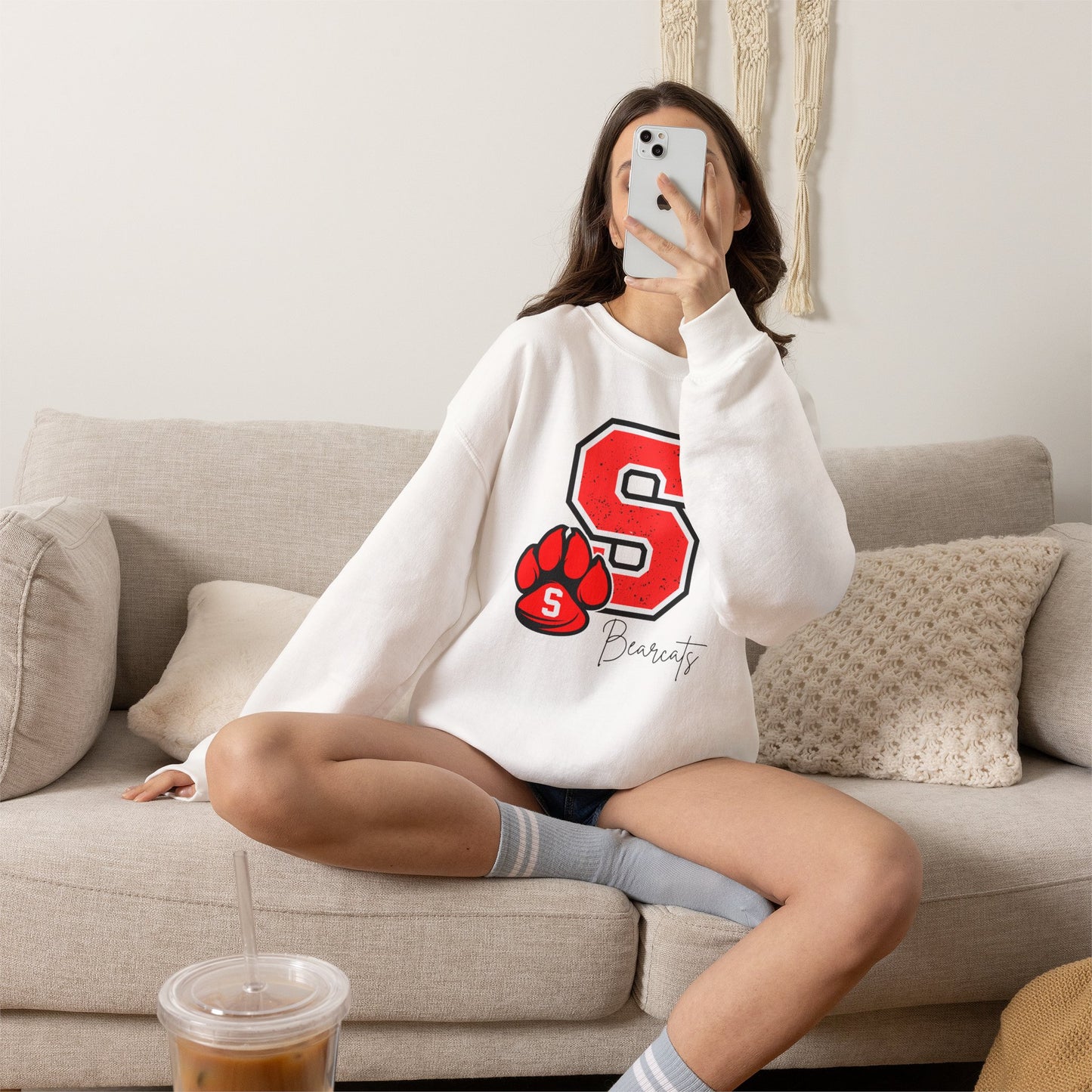 White crewneck sweatshirt with red S paw graphic and Bearcats logo on front