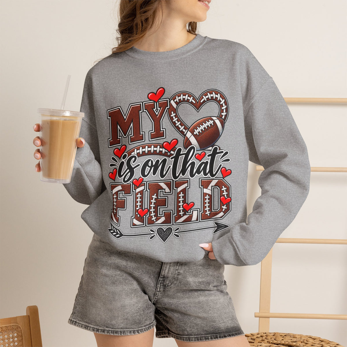 Heather gray crewneck sweatshirt with football graphic and hearts, long sleeves