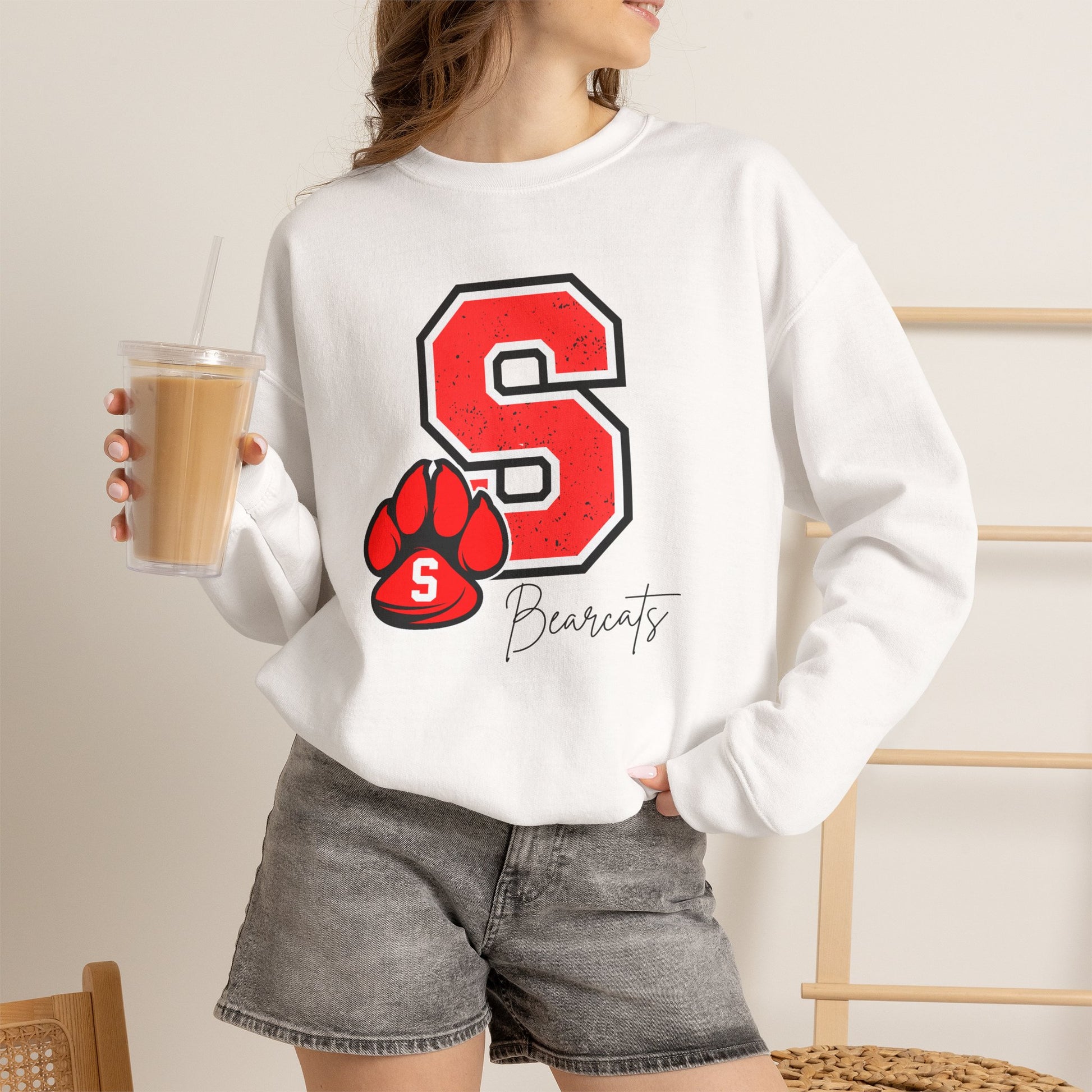 White crewneck sweatshirt worn by model; red S paw and Bearcats logo on front