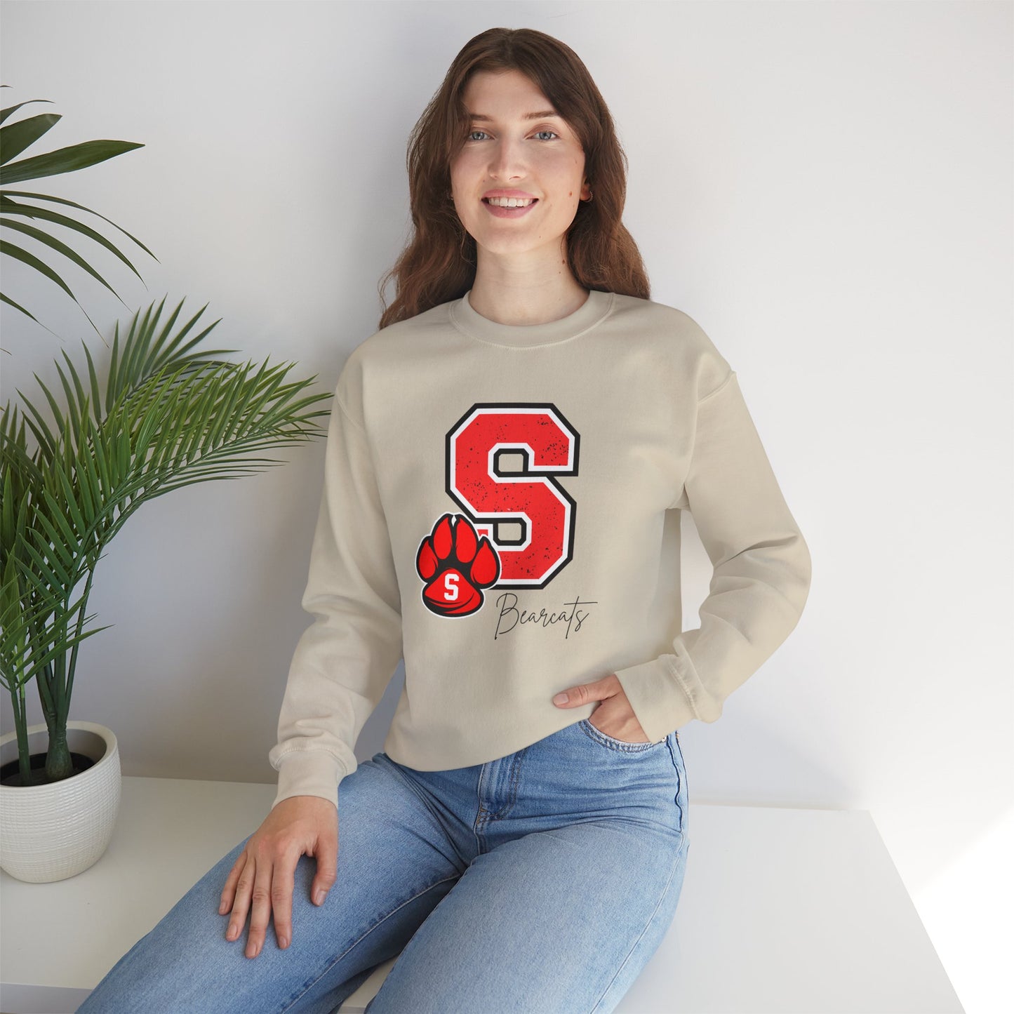 Beige crewneck sweatshirt featuring a red varsity S and paw print graphic on the chest