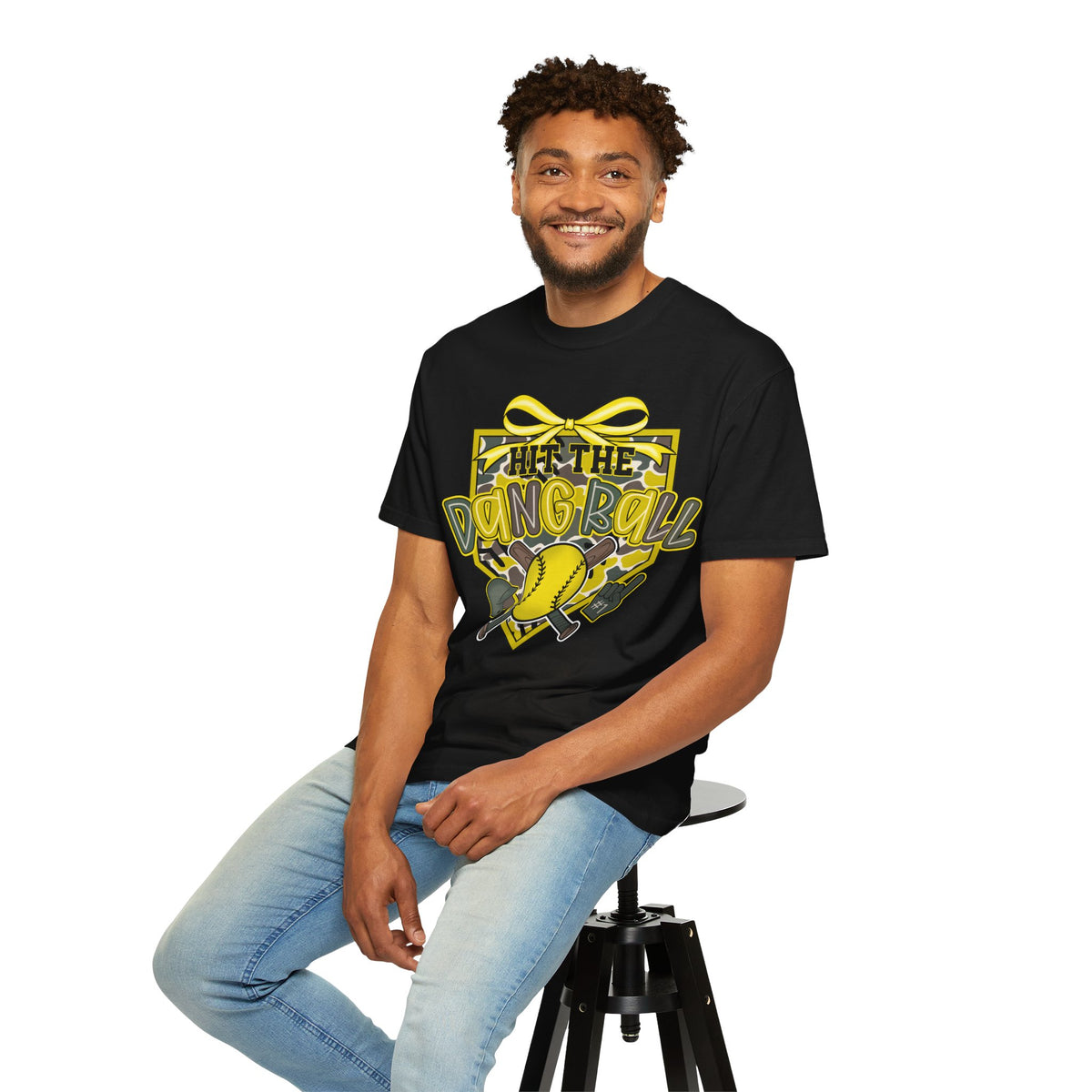 Black softball graphic tee on seated model with yellow bow and baseball graphic