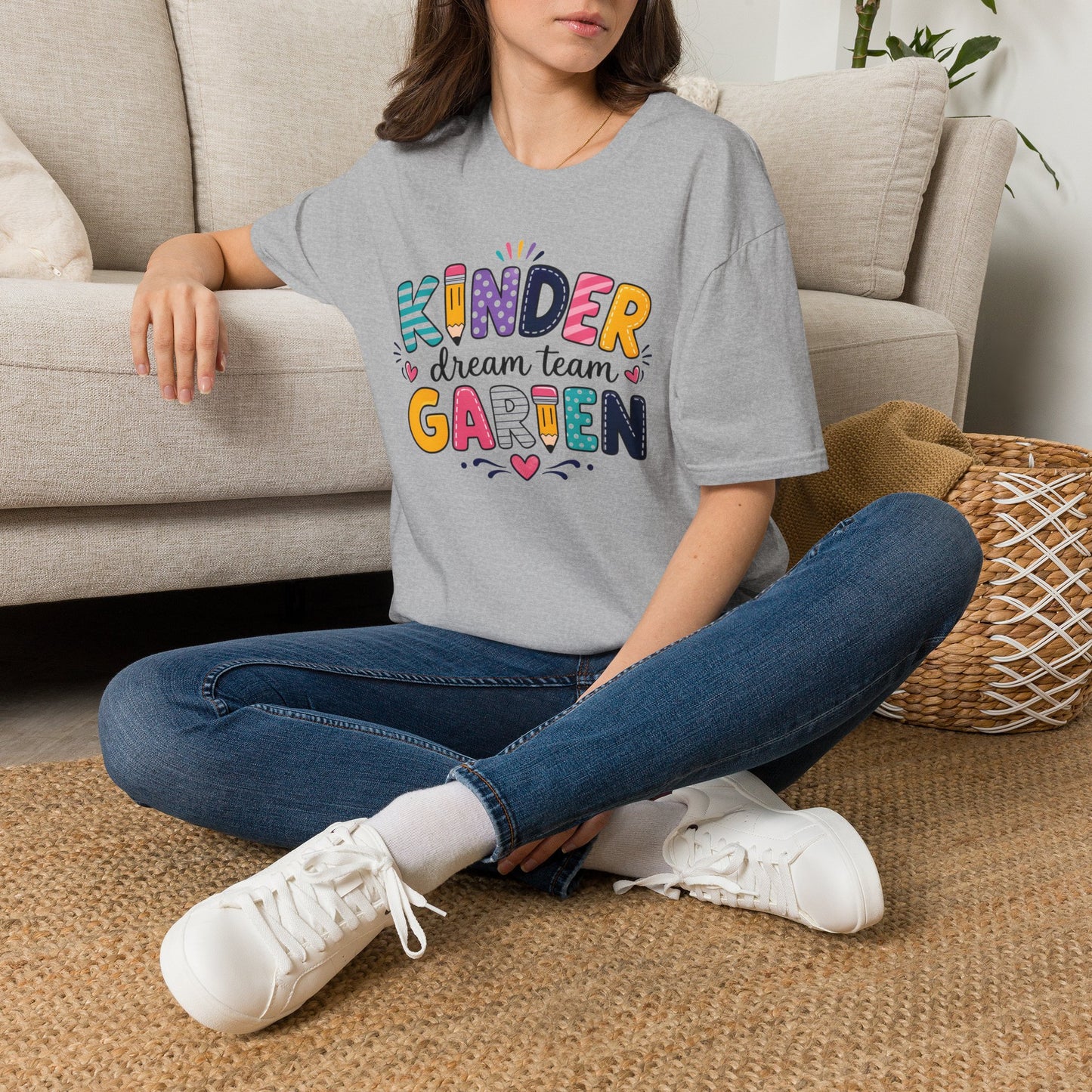 Sport grey kids graphic T-shirt worn with jeans and white sneakers; colorful "KINDER" print