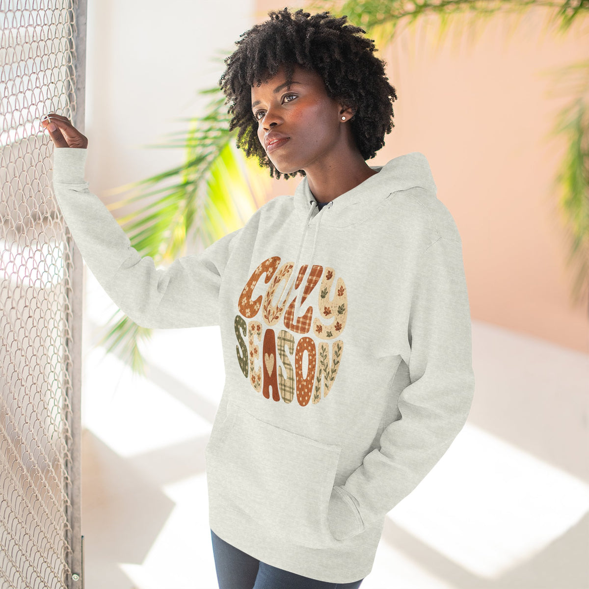 Heather gray fleece hoodie on model with drawstring hood, front pocket, and “Cozy Season” graphic
