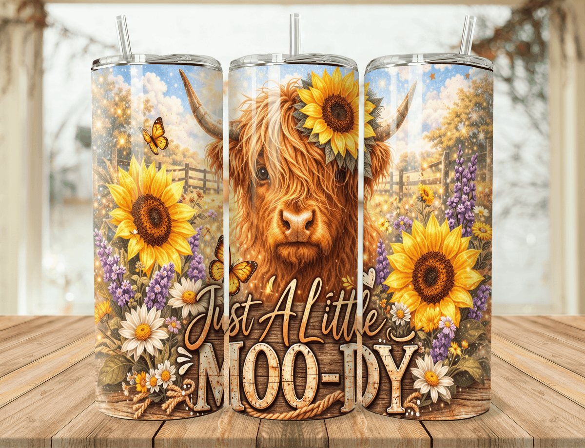 20oz tumbler with cow portrait, sunflowers, straw, “Just A Little MOO-dy” text