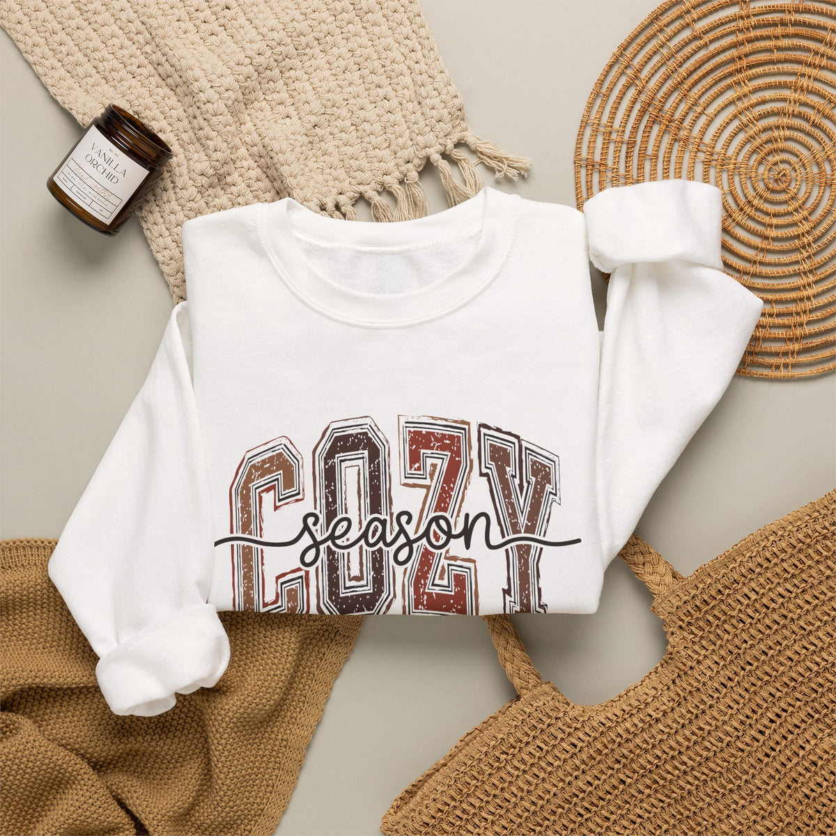 White crewneck sweatshirt with Cozy Season front graphic, long sleeves