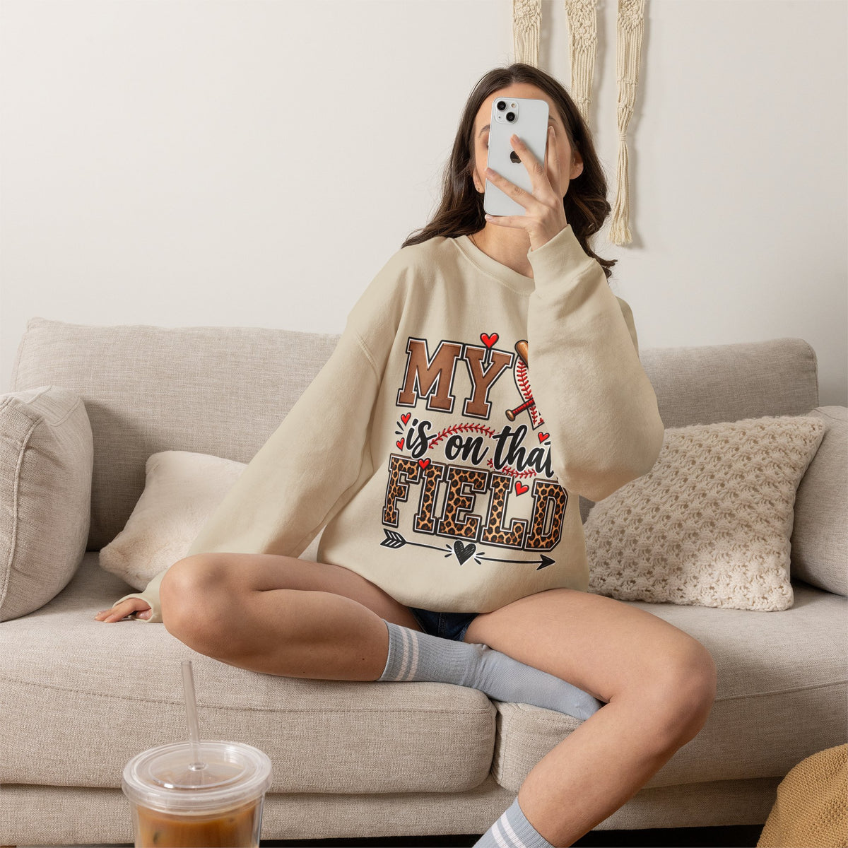Sand crewneck sweatshirt with baseball heart and crossed bats front graphic, worn