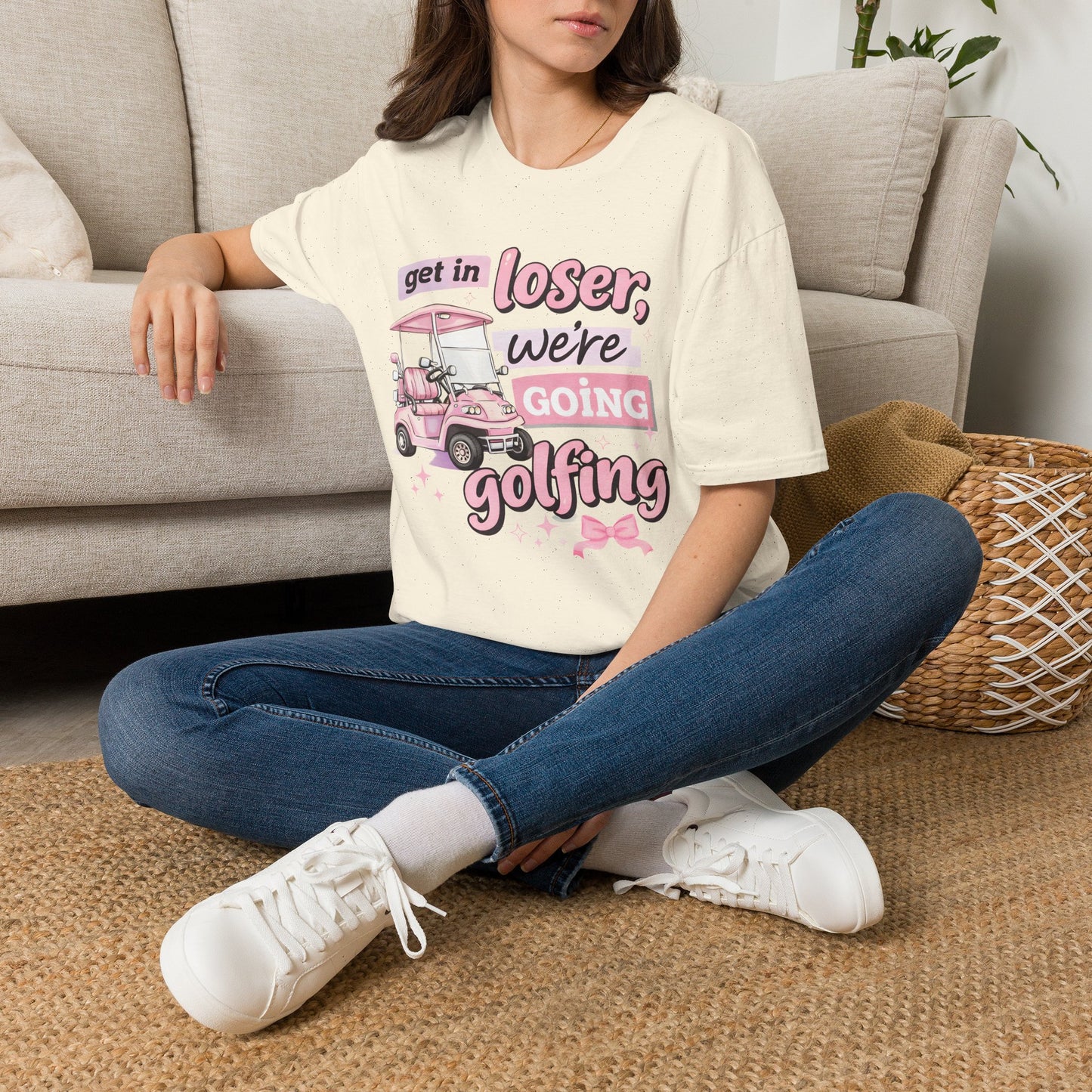 Cream T-shirt worn on model with pink “Get in Loser” golf cart graphic