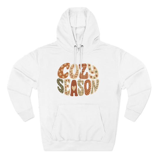 White fleece pullover hoodie with “COZY SEASON” leopard-style graphic on front