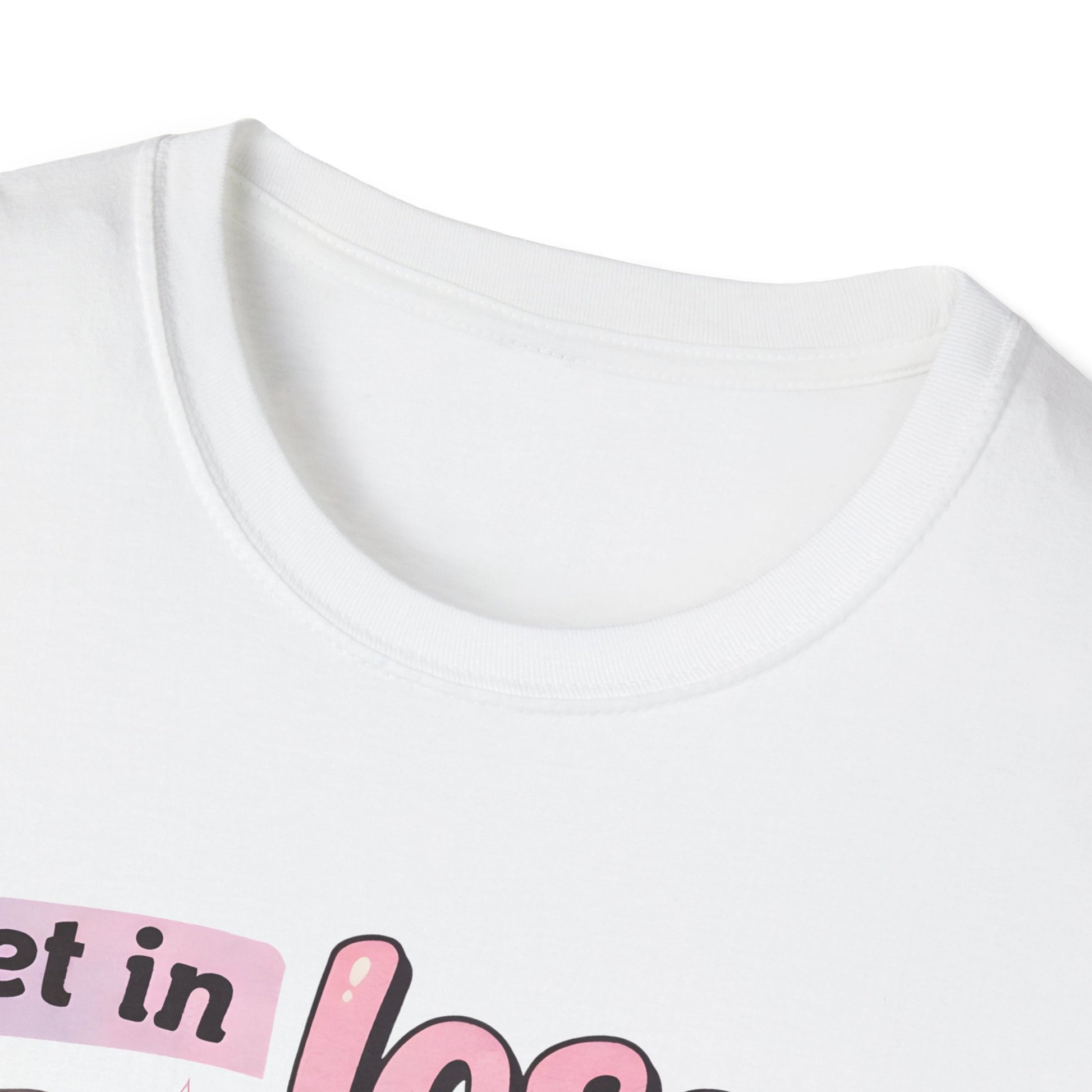 White T-shirt neckline close-up with pink golf cart and “we’re going golfing” graphic