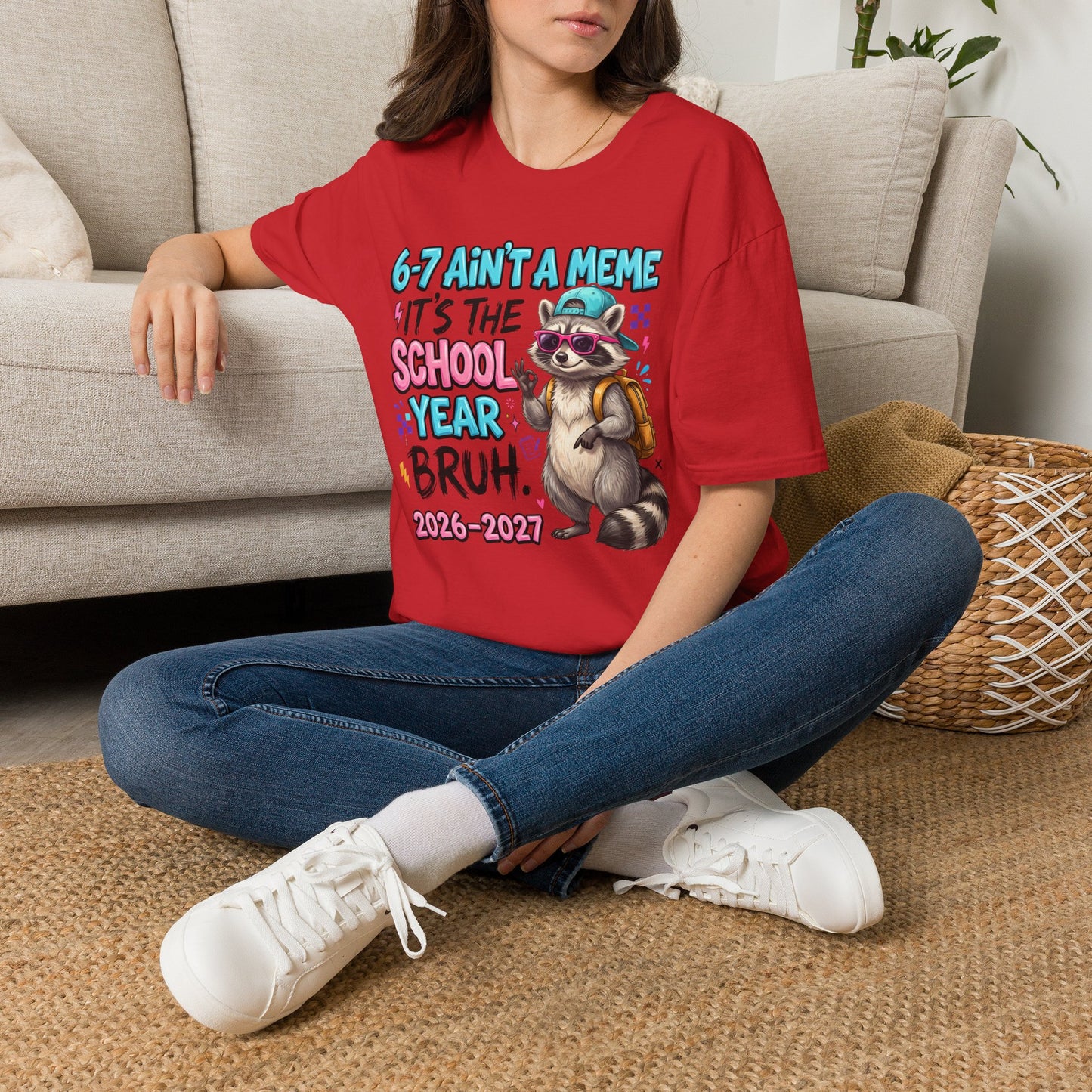 Red crew-neck T-shirt with raccoon school graphic, worn.