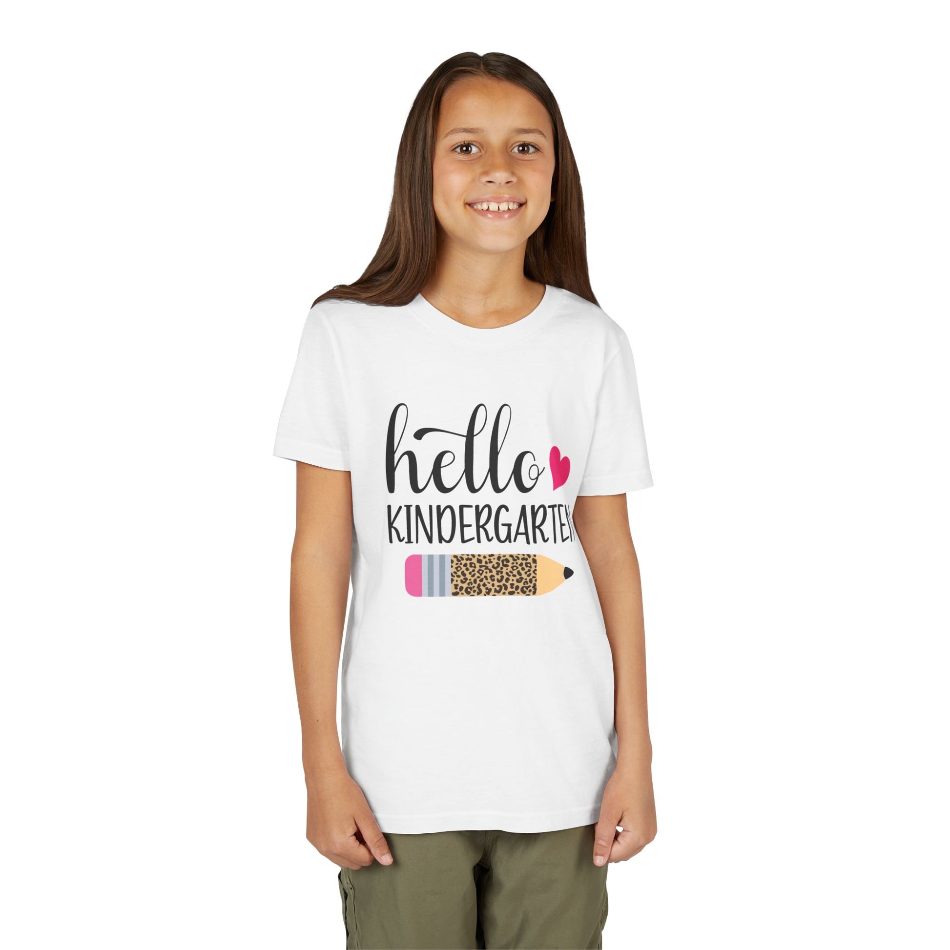White youth T-shirt on child model with 'Hello Kindergarten' pink heart pencil graphic
