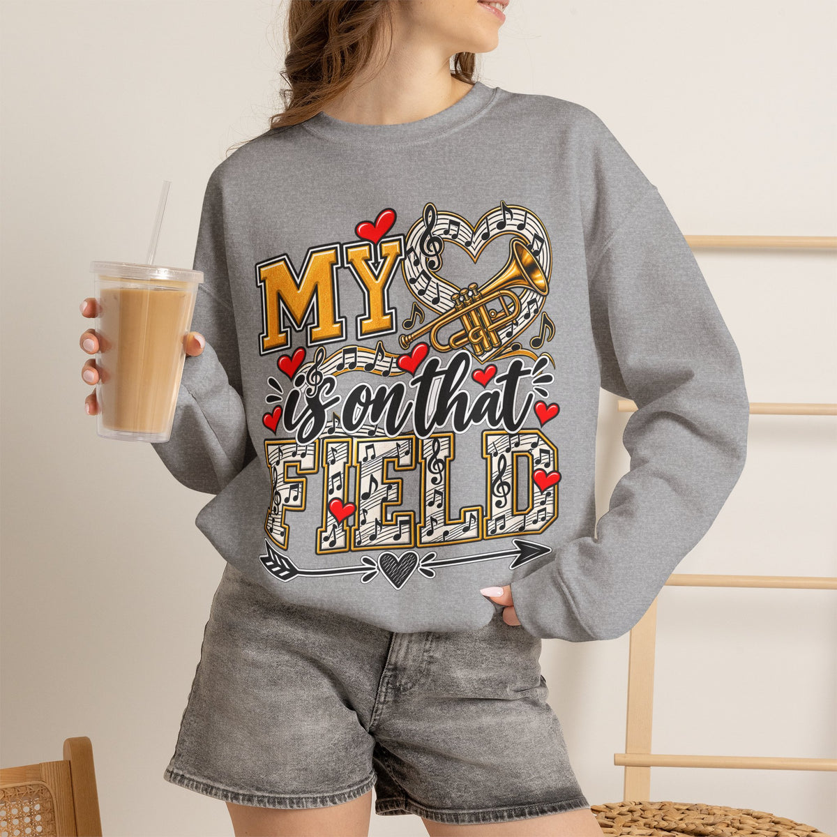 Grey long-sleeve sweatshirt with trumpet graphic, “My” text, and red heart details