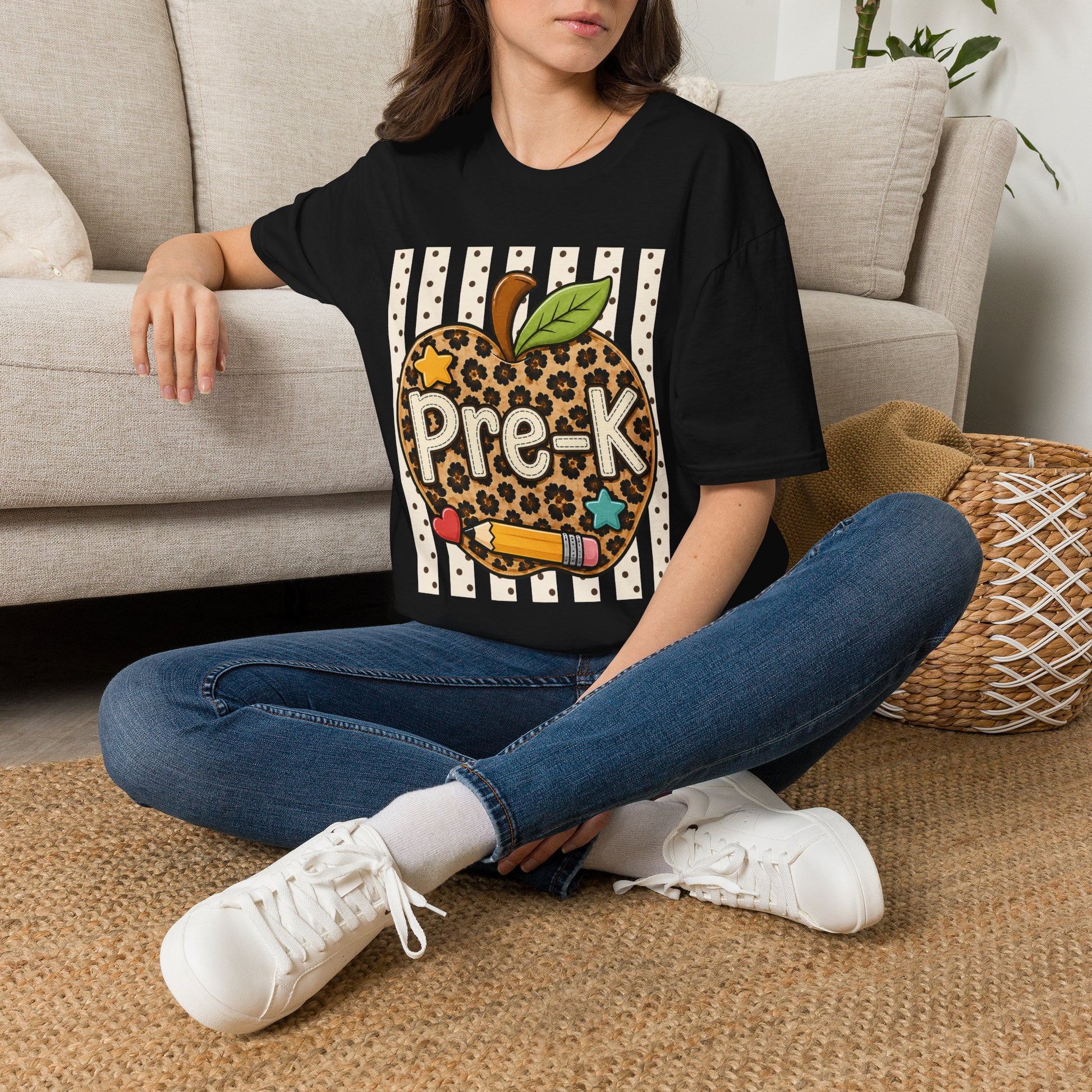Black preschool T-shirt with leopard-print apple “Pre-K” graphic, worn sitting