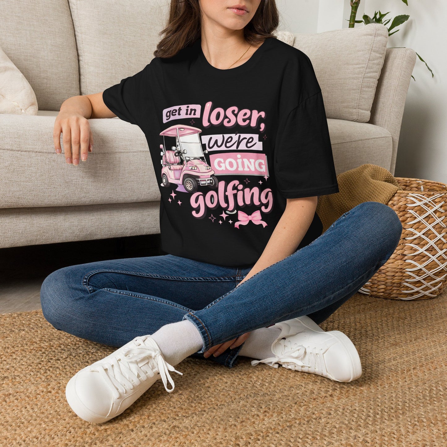 Black golfing graphic T-shirt with pink text and cart illustration on chest