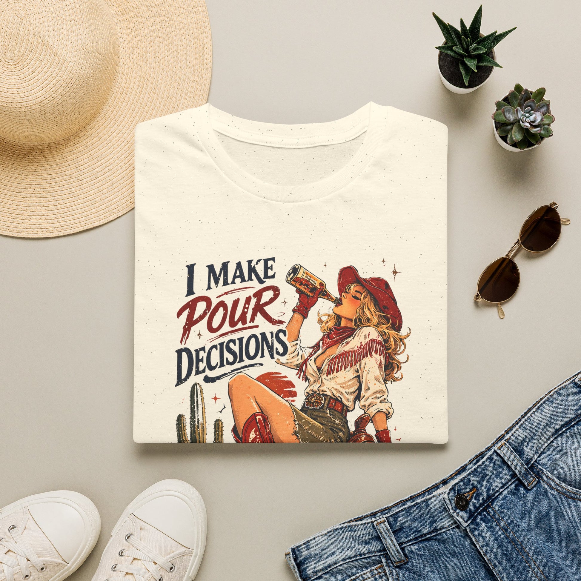 Natural cowgirl T-shirt laid flat with retro western “I Make Pour Decisions” print