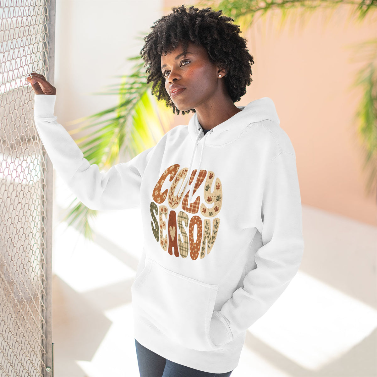 White fleece pullover hoodie with “COZY SEASON” leopard-style graphic on front