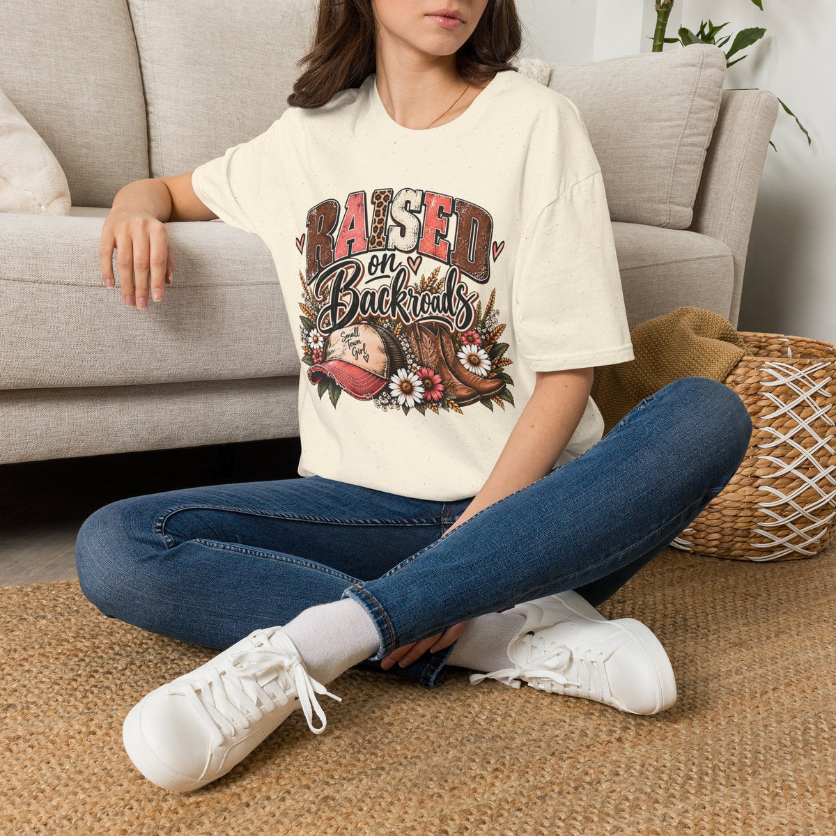 Natural crew-neck t-shirt with front graphic, modeled on a sitting woman