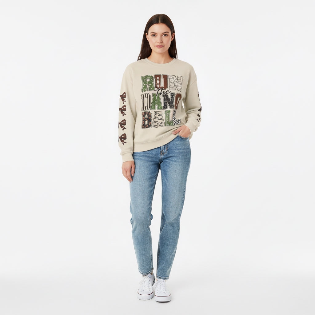 Sand crewneck sweatshirt with 'Run the Dang Ball' patchwork graphic, ribbon sleeve print