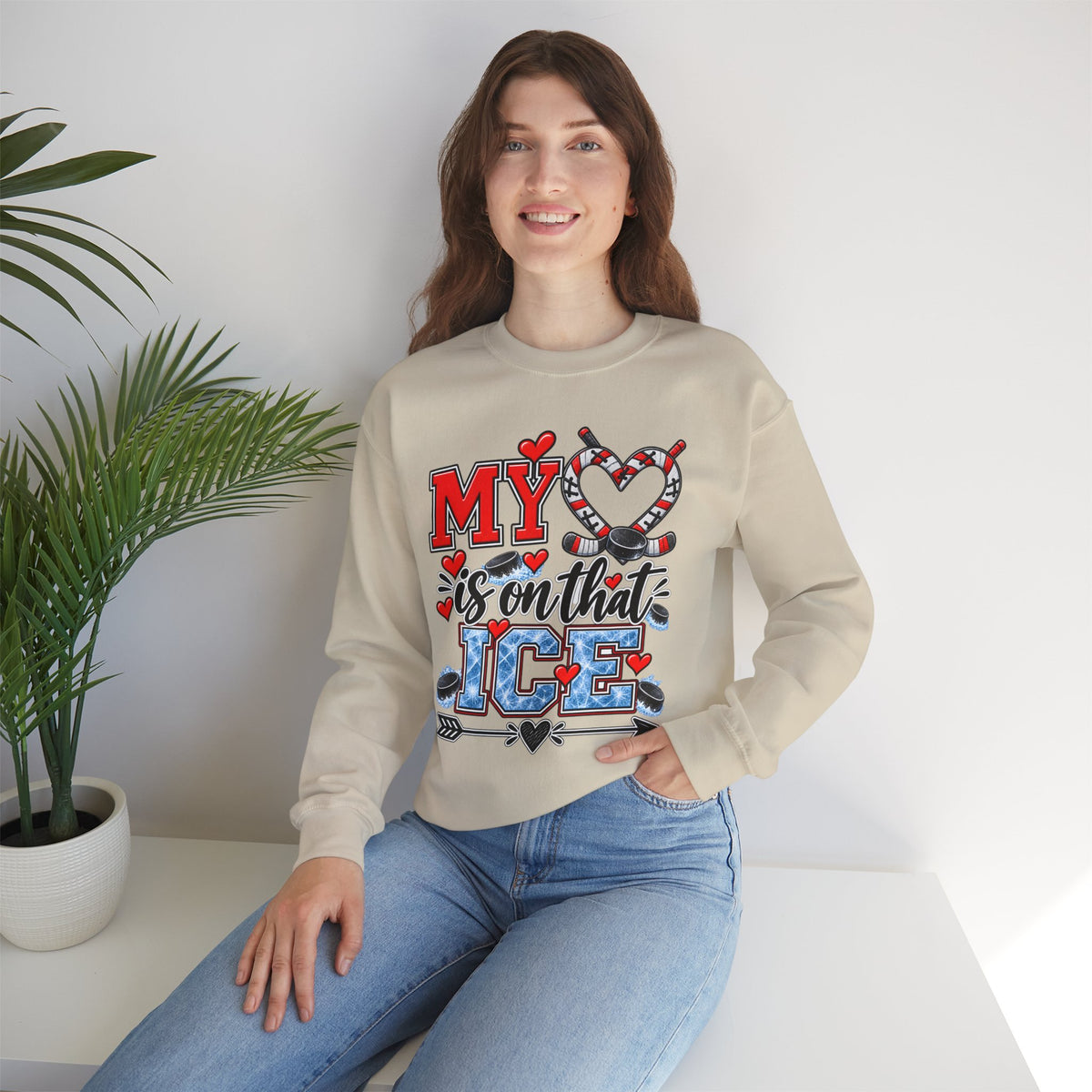 Sand sweatshirt with front heart and ice skate graphic, worn by a model