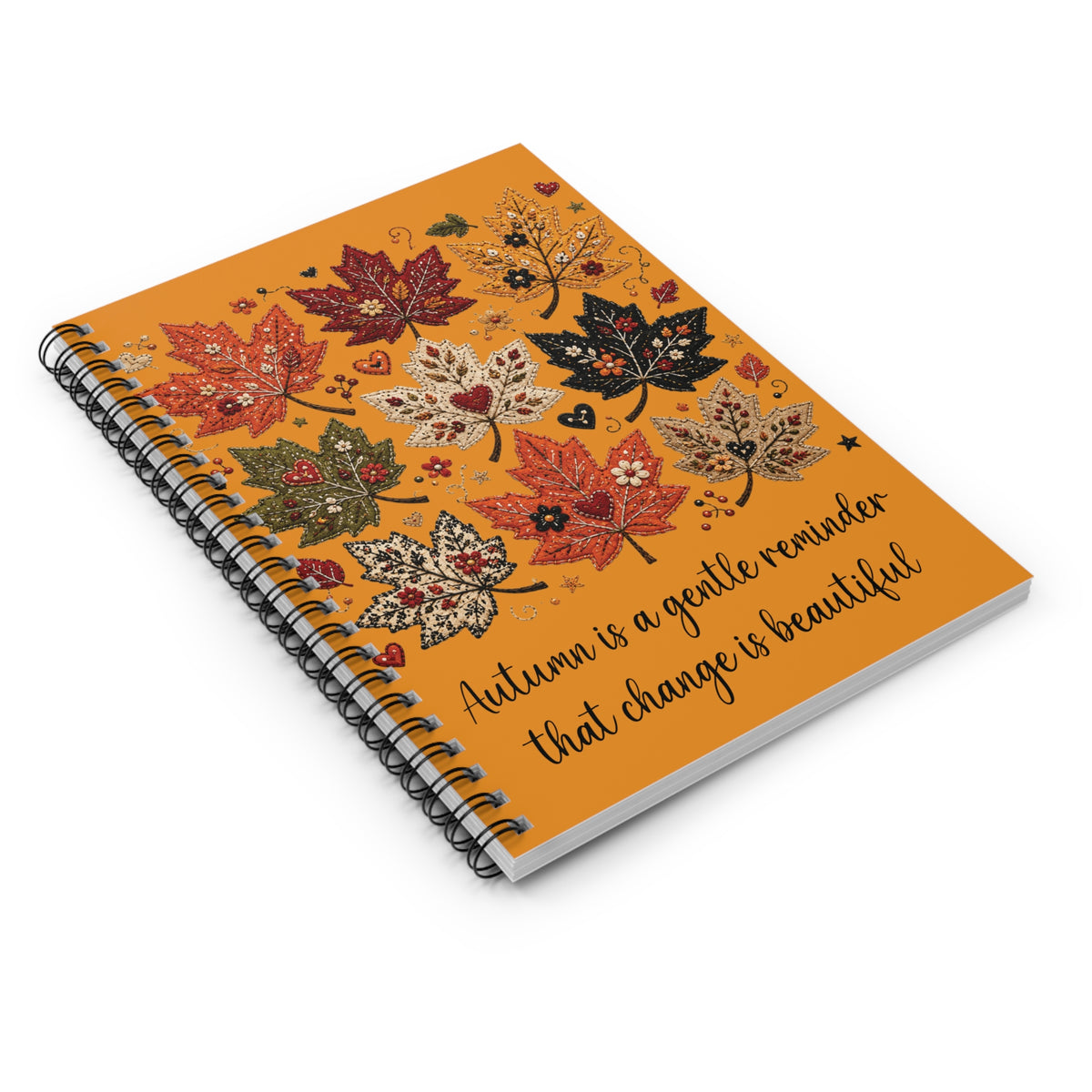 Autumn leaf spiral notebook with orange cover, leaf illustrations, and quote, angled
