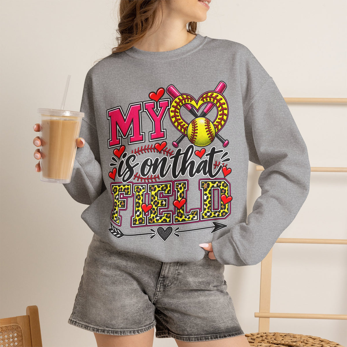 Gray crewneck sweatshirt with large softball heart graphic; long sleeves